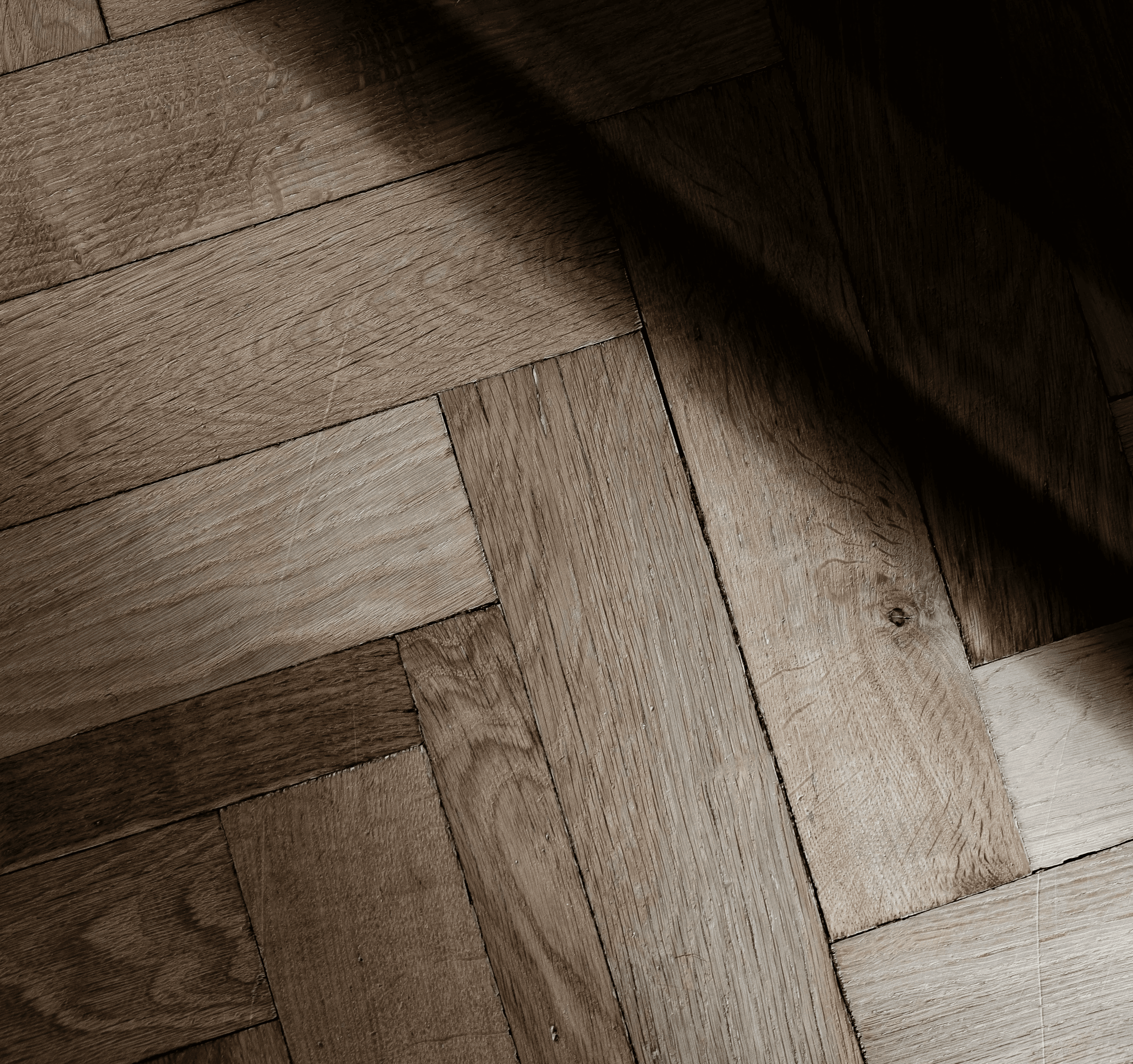 a wooden floor with a light shining on it