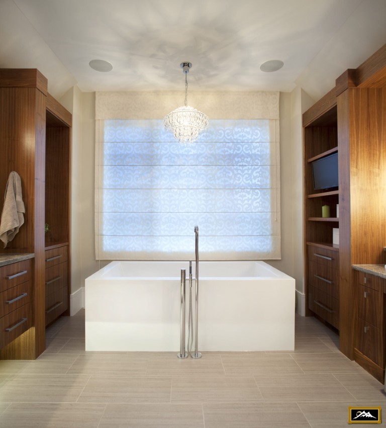 Image of Luxurious primary ensuites with freestanding tub, custom cabinetry and elegant window coverings by KHD Homes.