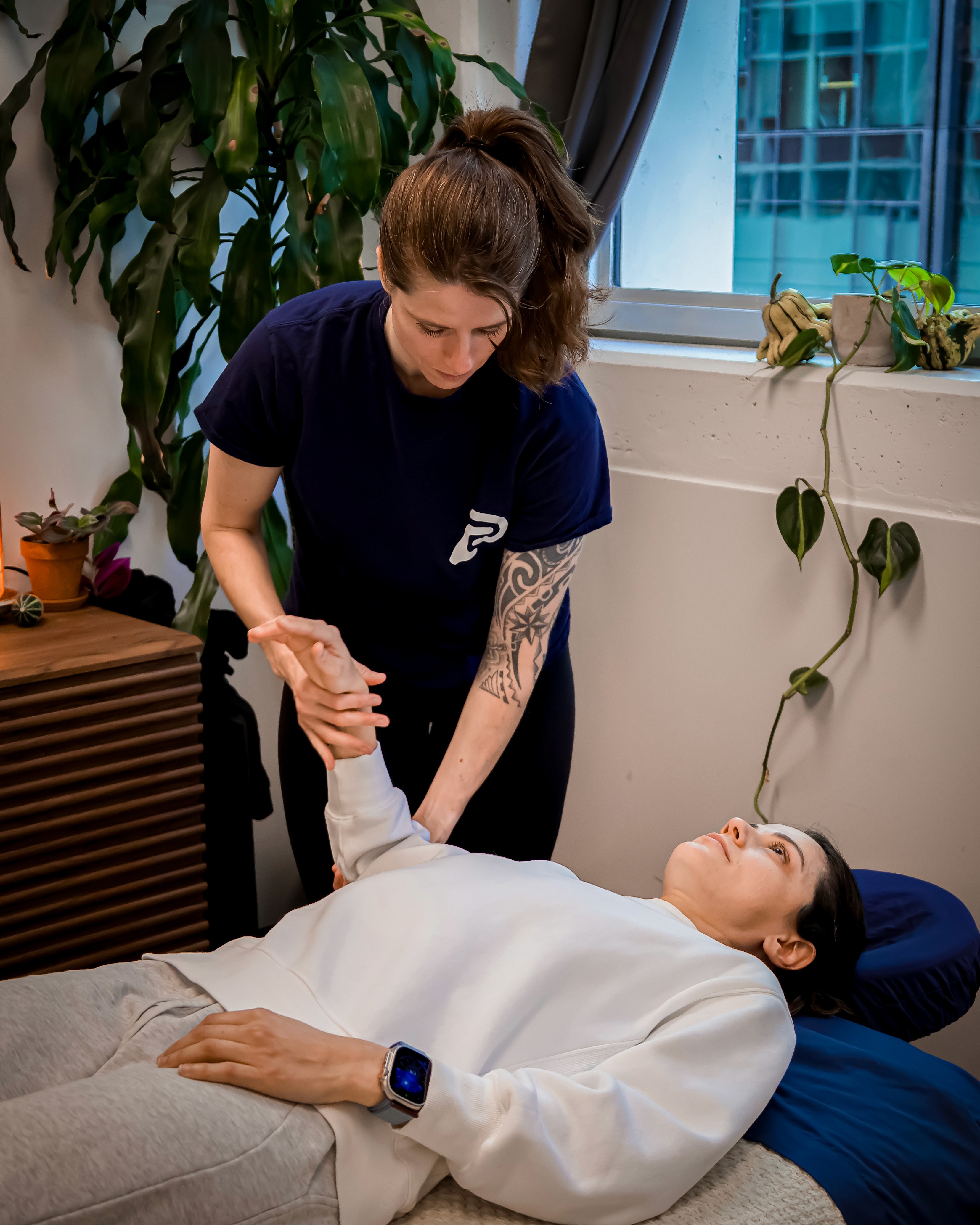 RMT massaging a patient's arm on a table