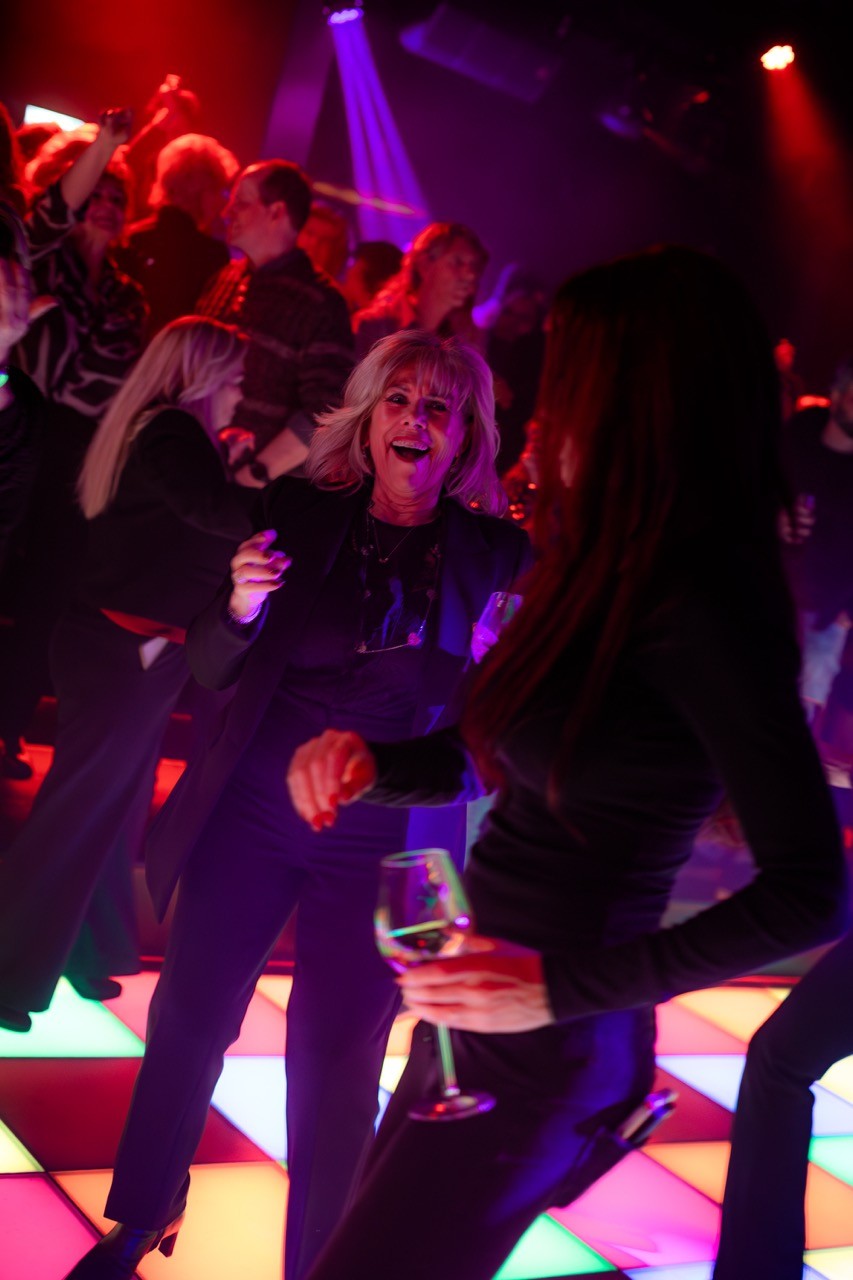 people dancing and laughing at a nightclub