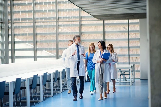 doctors walking down glass building