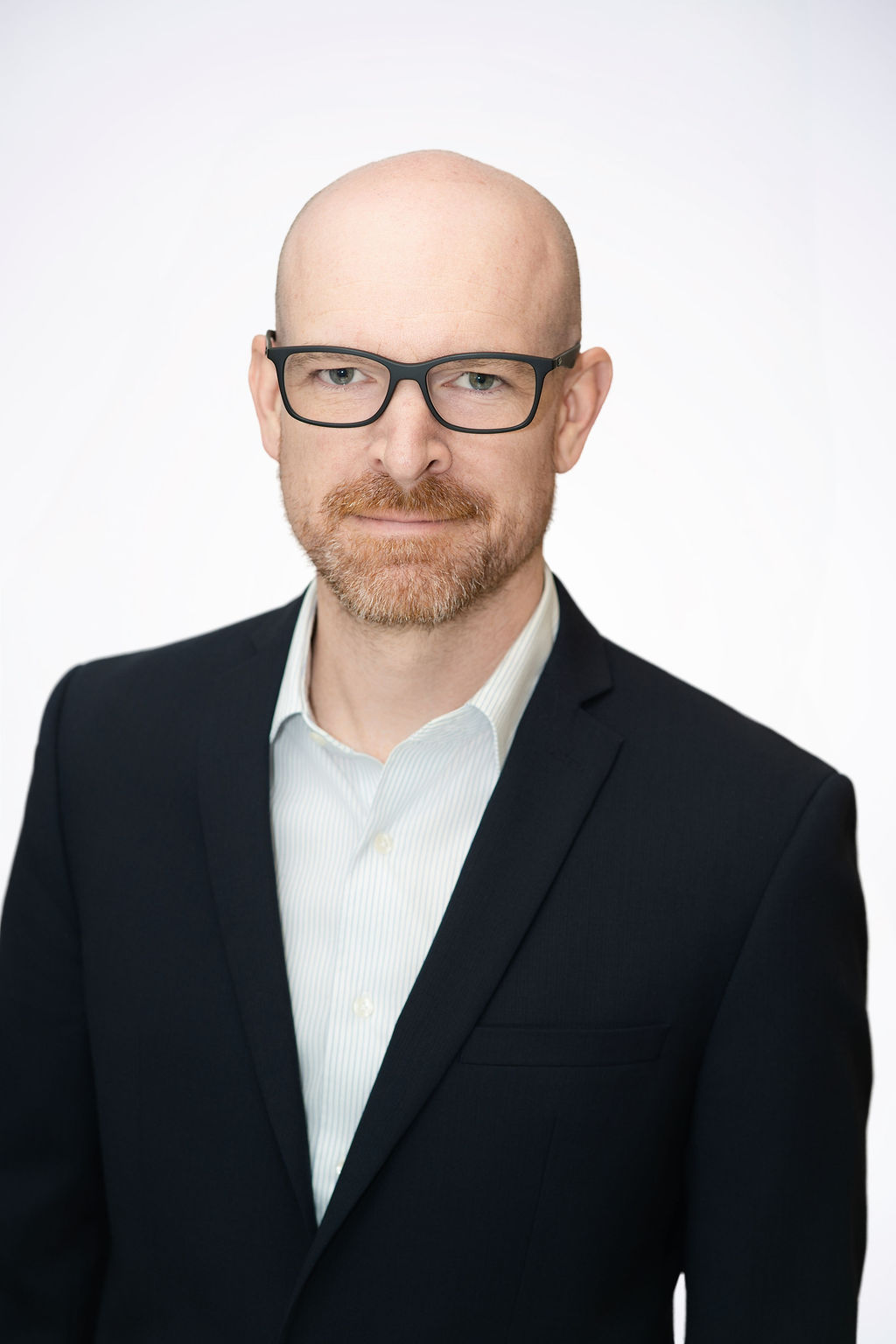 Scientist looking through a microscope in a lab.