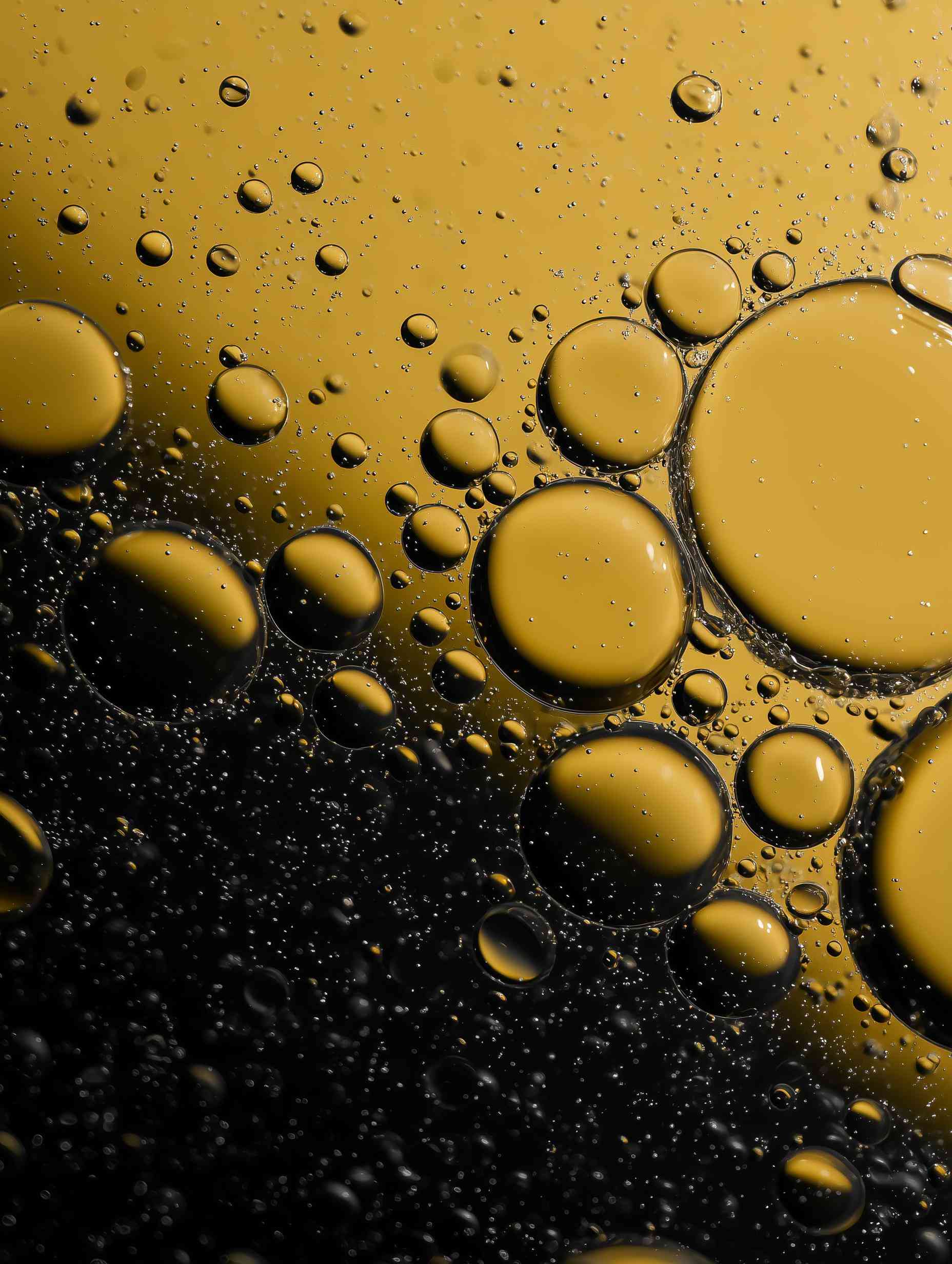 Amber oil bubbles dispersed across textured surface