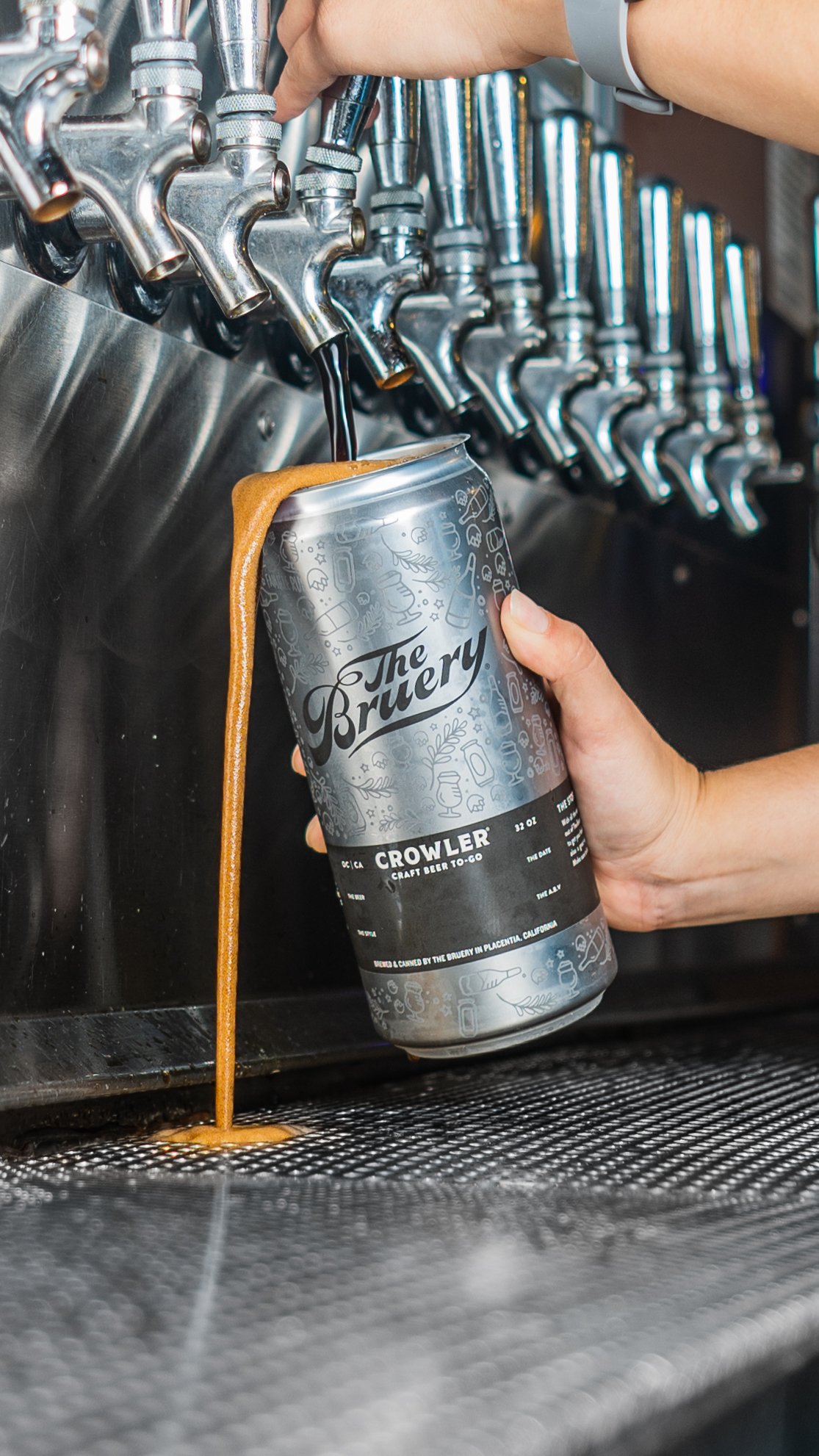 Hand holding The Bruery growler can