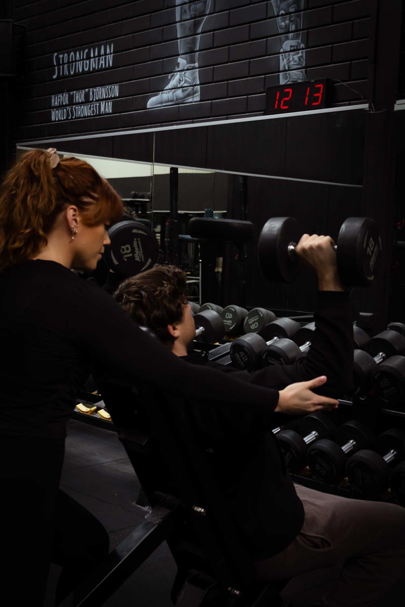 Client working triceps and back muscles