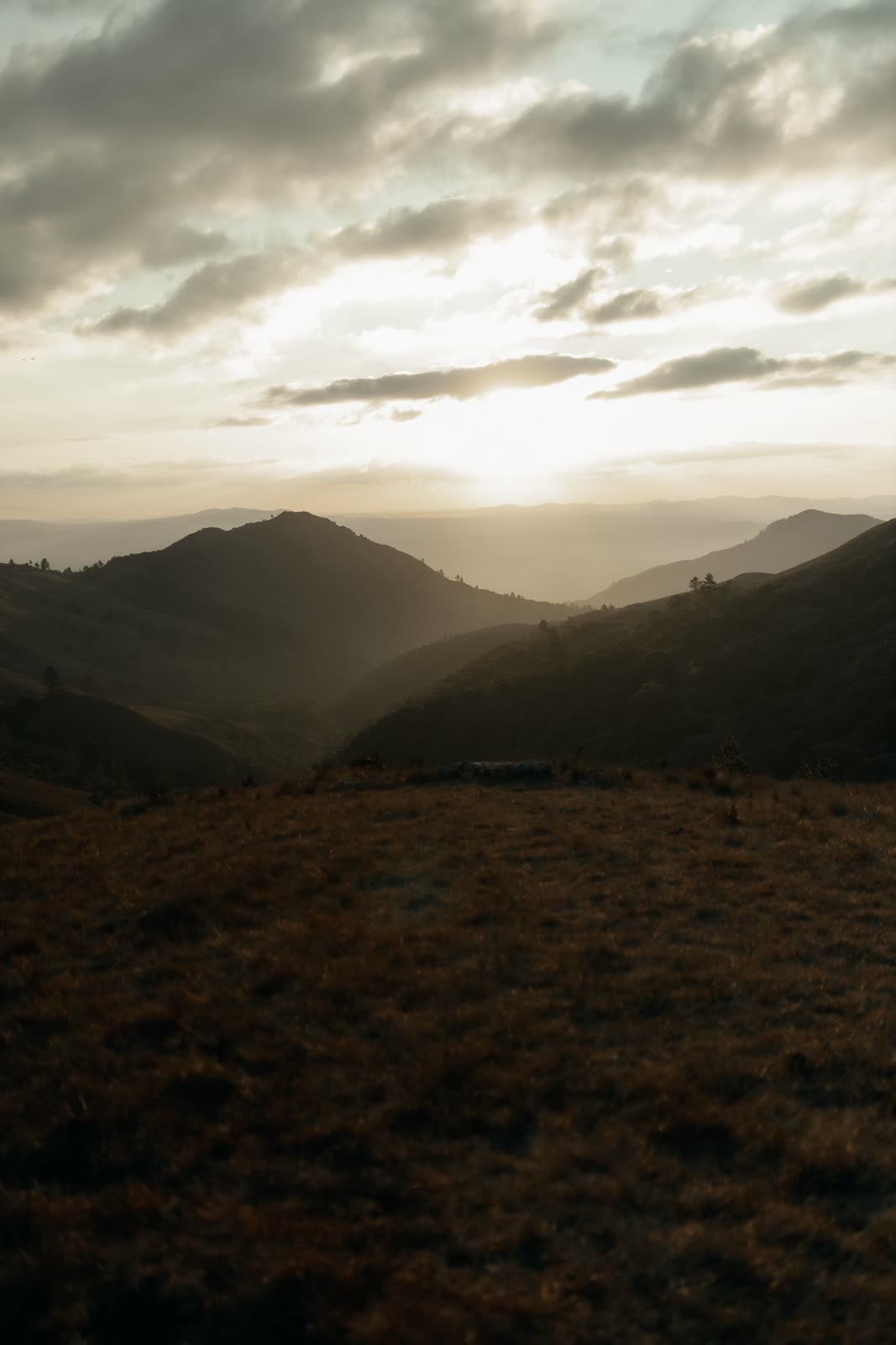 Layered mountain valley in warm haze with no people