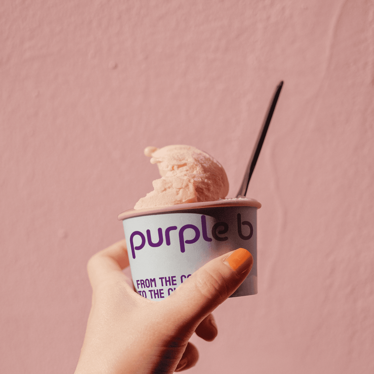 Open pizza box next to glass of wine