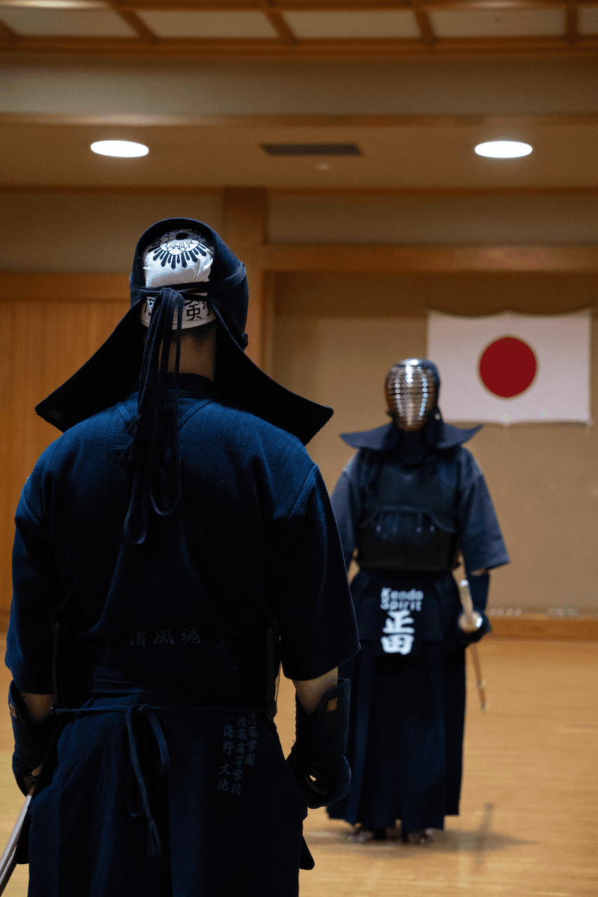 Two kendo martial artists facing off