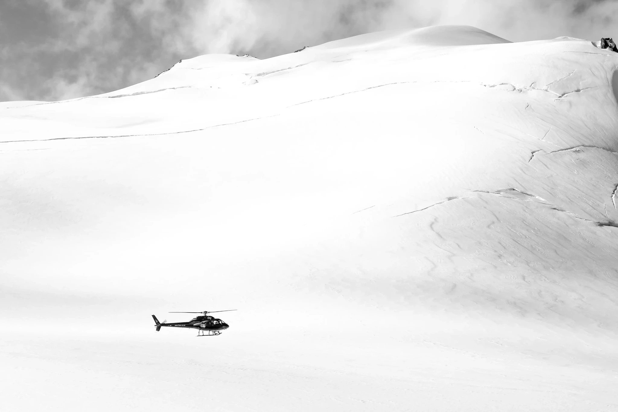 Helicopter flying over snowy Southern Alps near Queenstown New Zealand