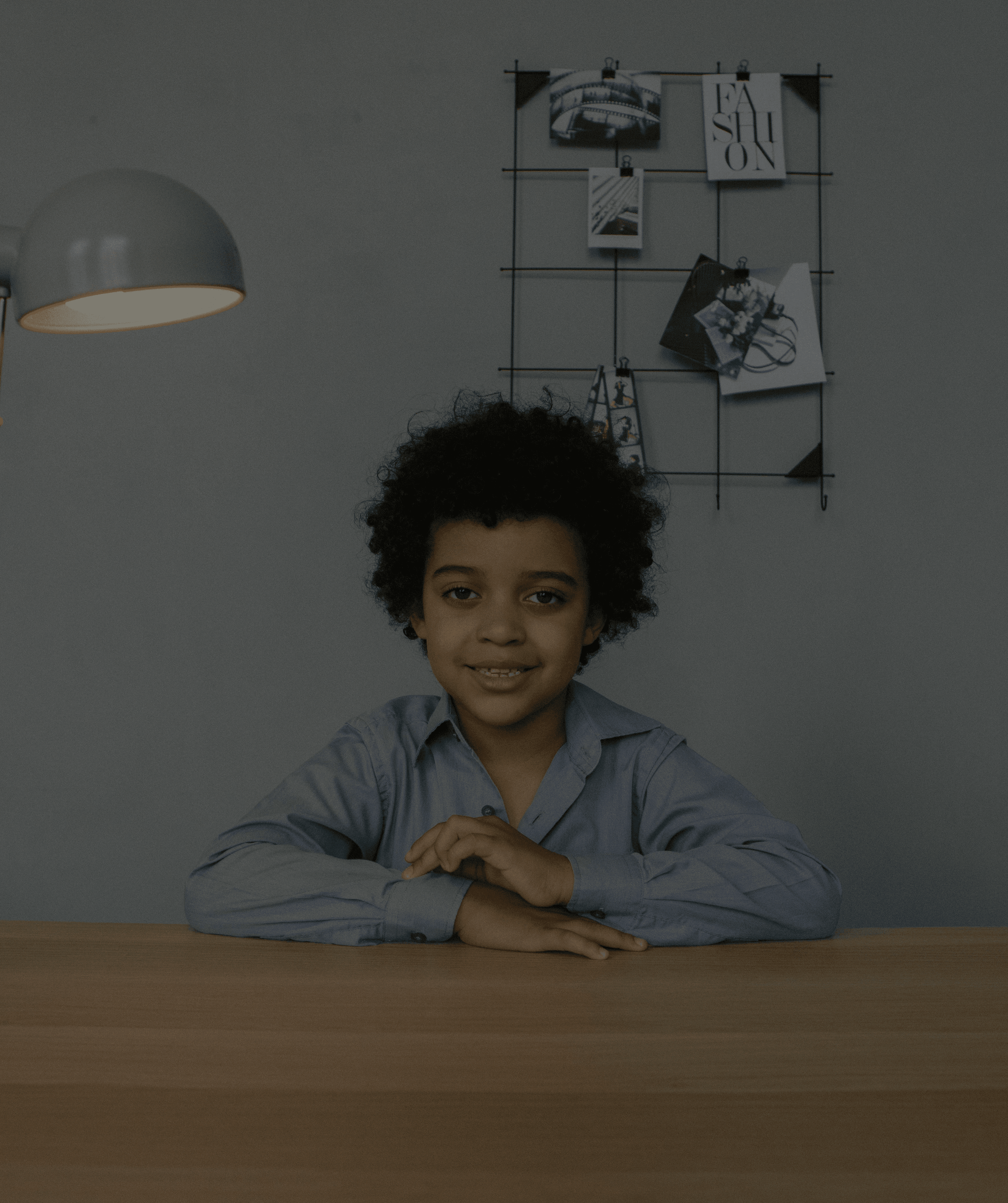 A young child sitting calmly at a desk, representing hope and confidence for children managing tics with CBIT treatment.