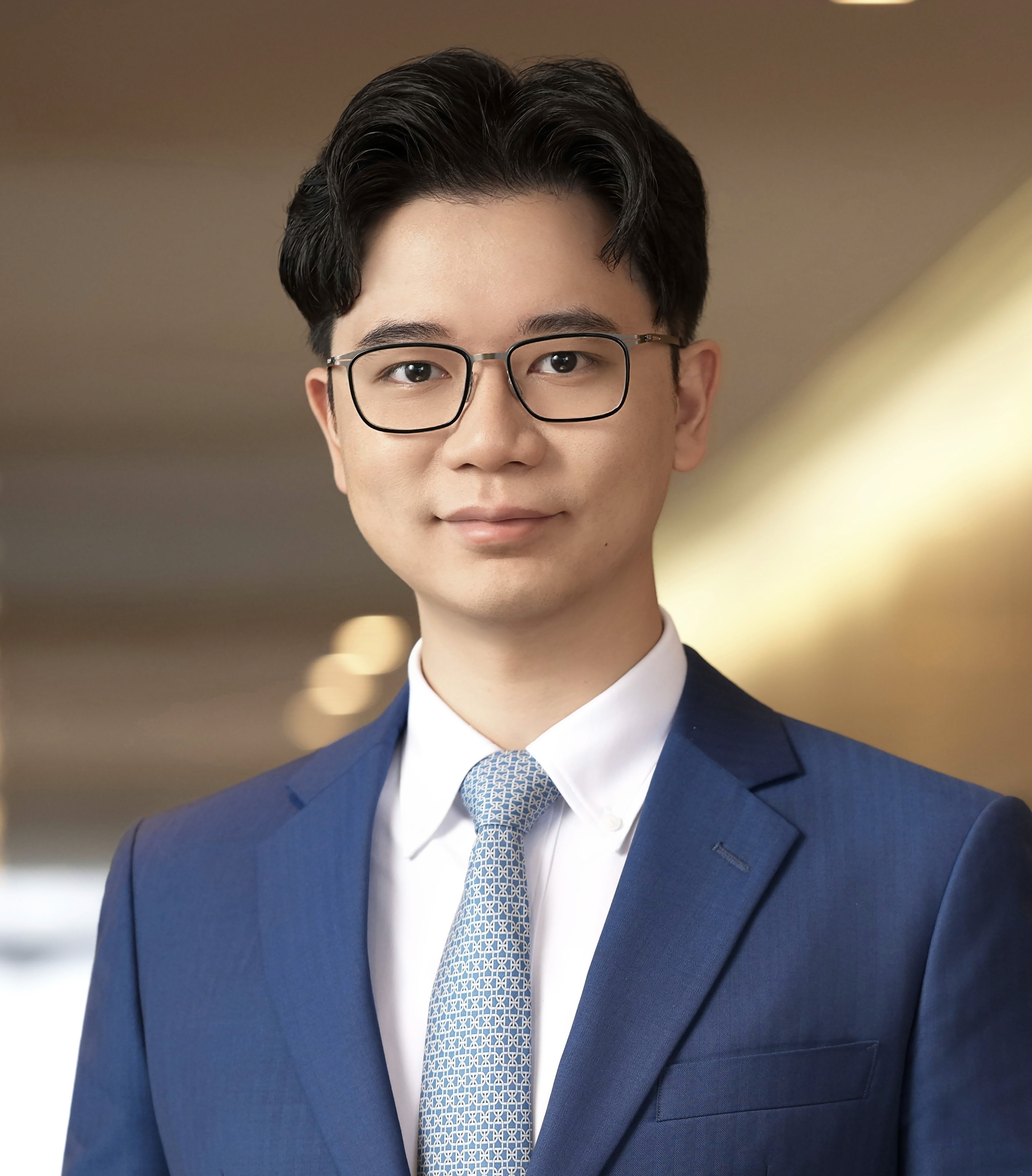 Silhouette of a researcher examining a slide under a microscope with a blue background.