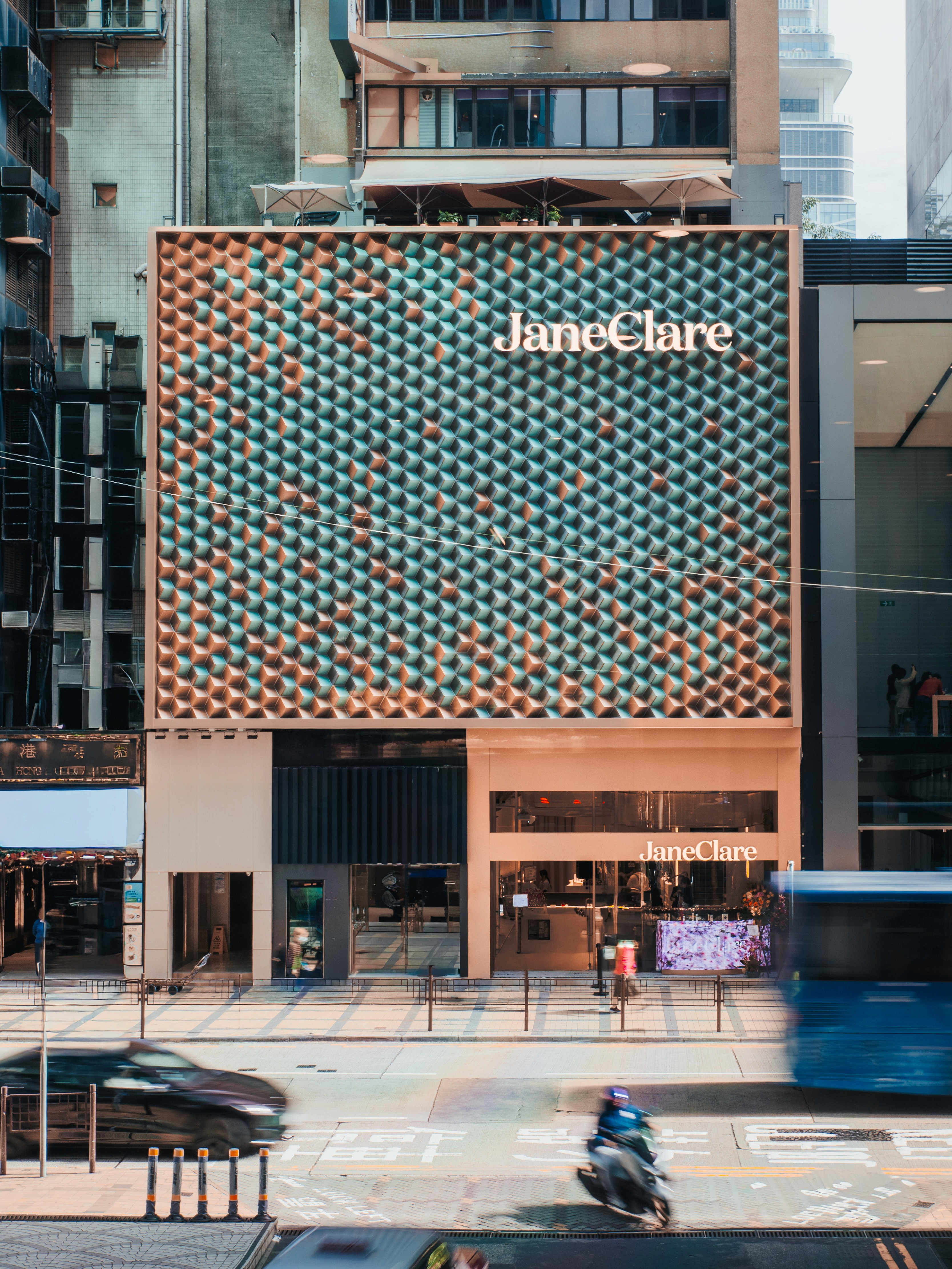Exterior view of the JaneClare flagship store building in a busy Hong Kong city street setting.