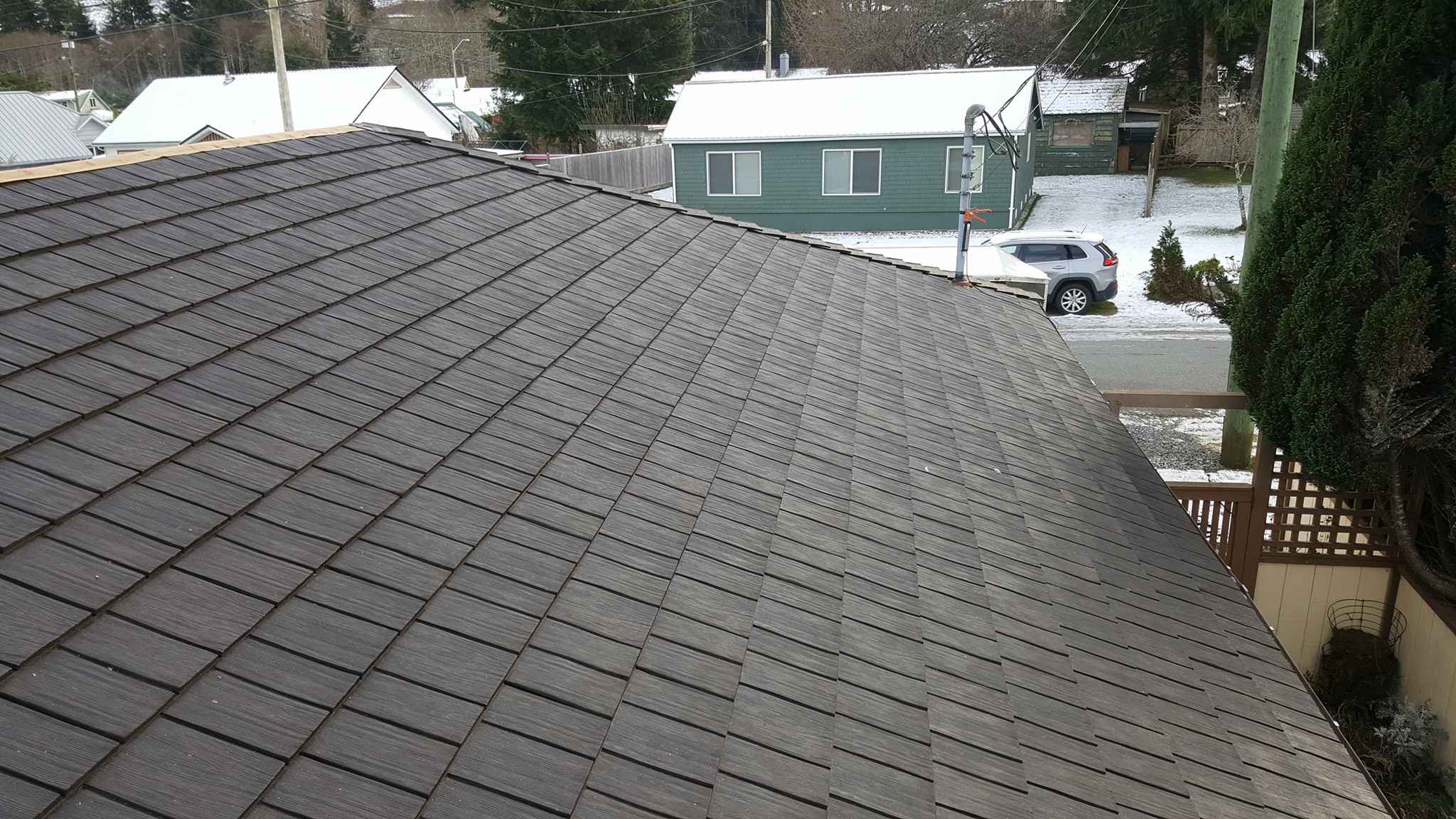 Modern loft interior with greenery, exposed brick walls, large glass windows, and vibrant yellow accents. Inviting atmosphere with natural light.