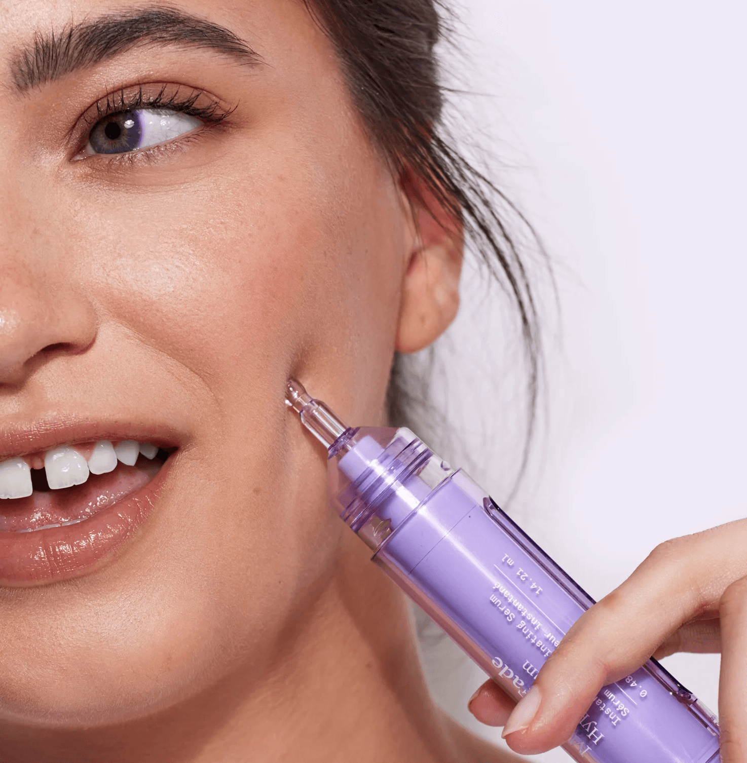 A model holding a Dr. Idriss skincare product