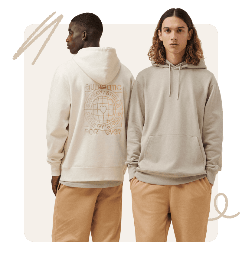 Two models stand back to back, wearing light-colored hoodies and tan pants on a neutral background.