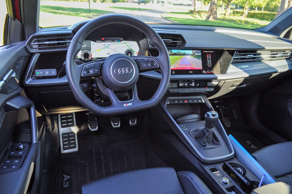 Close-up of a dark green leaf showing its textured surface and central vein against a muted background.
