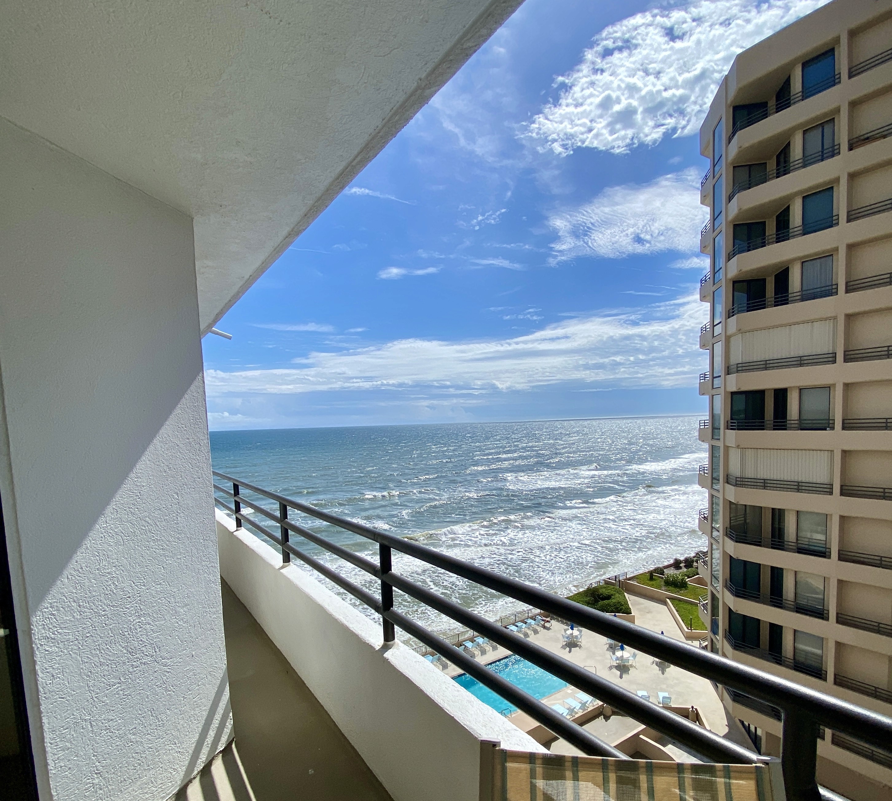 Balcony view of the ocean and pool below, Unit 703 at Oceans Atrium One, a vacation rental in Daytona Beach Shores