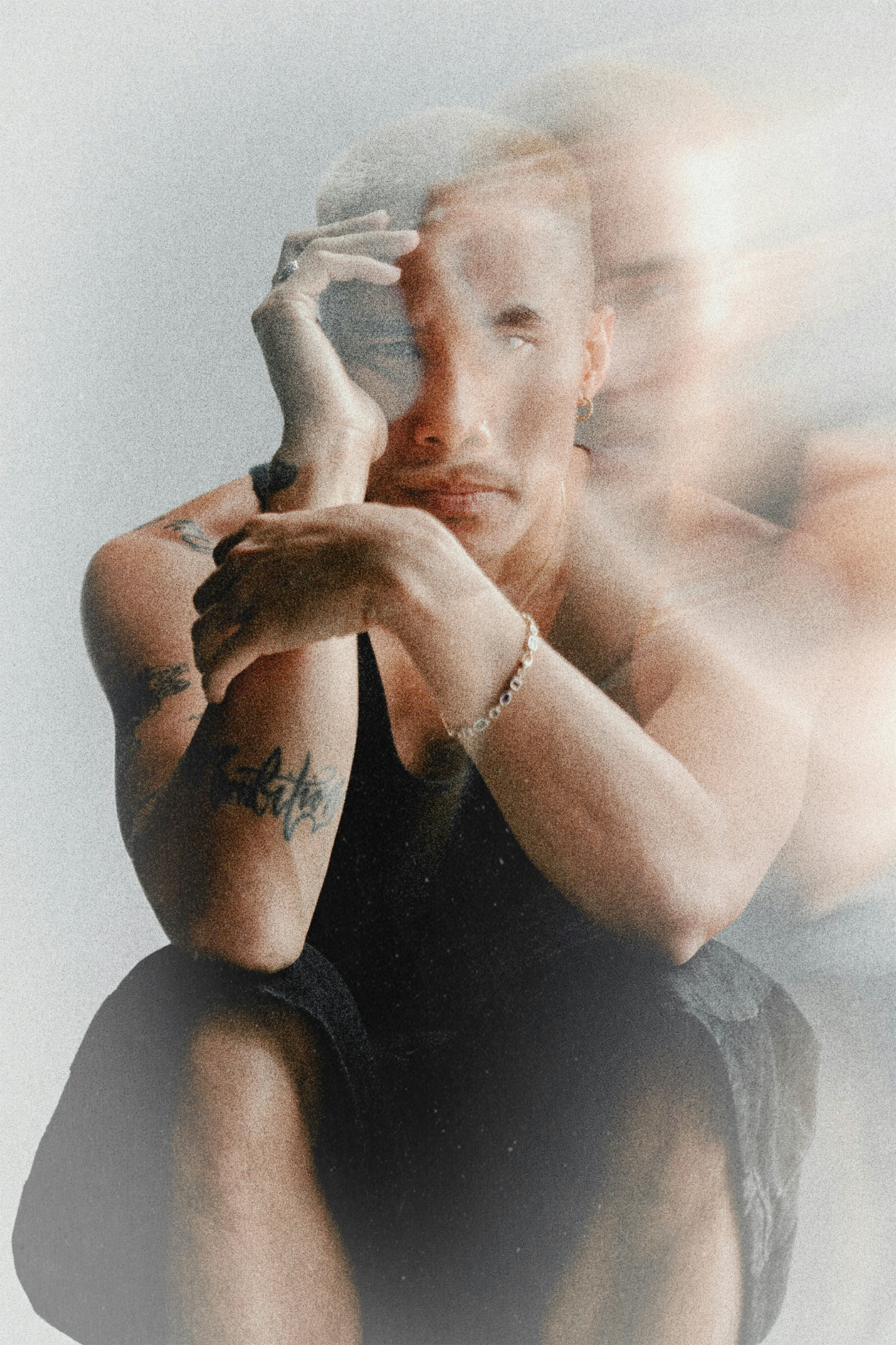 Close-up of hands with tattoos and gold jewelry, artistic detail shot from Pharmapro brand campaign