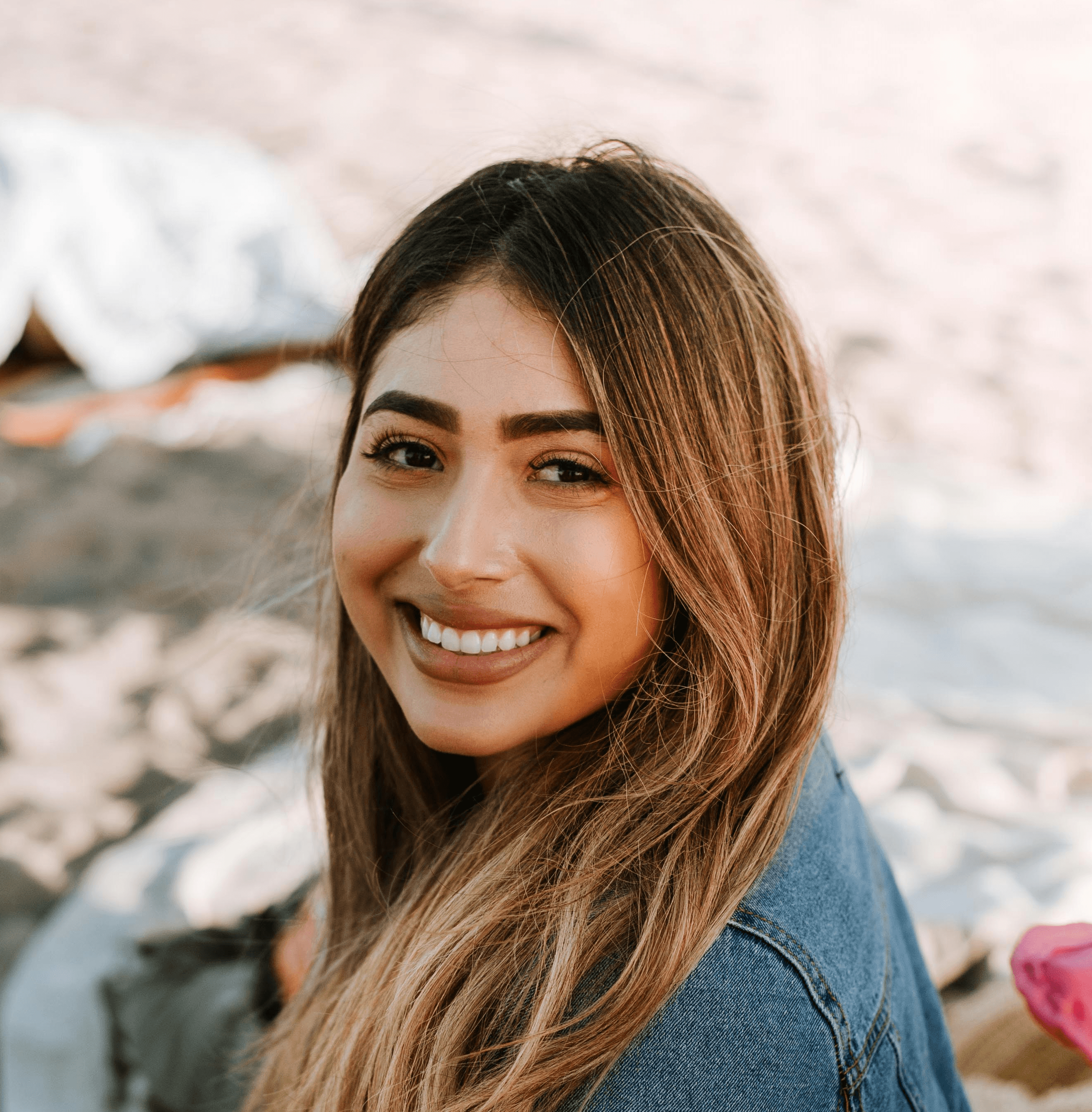 woman sitting on white, red, and black striped mat on top of stand