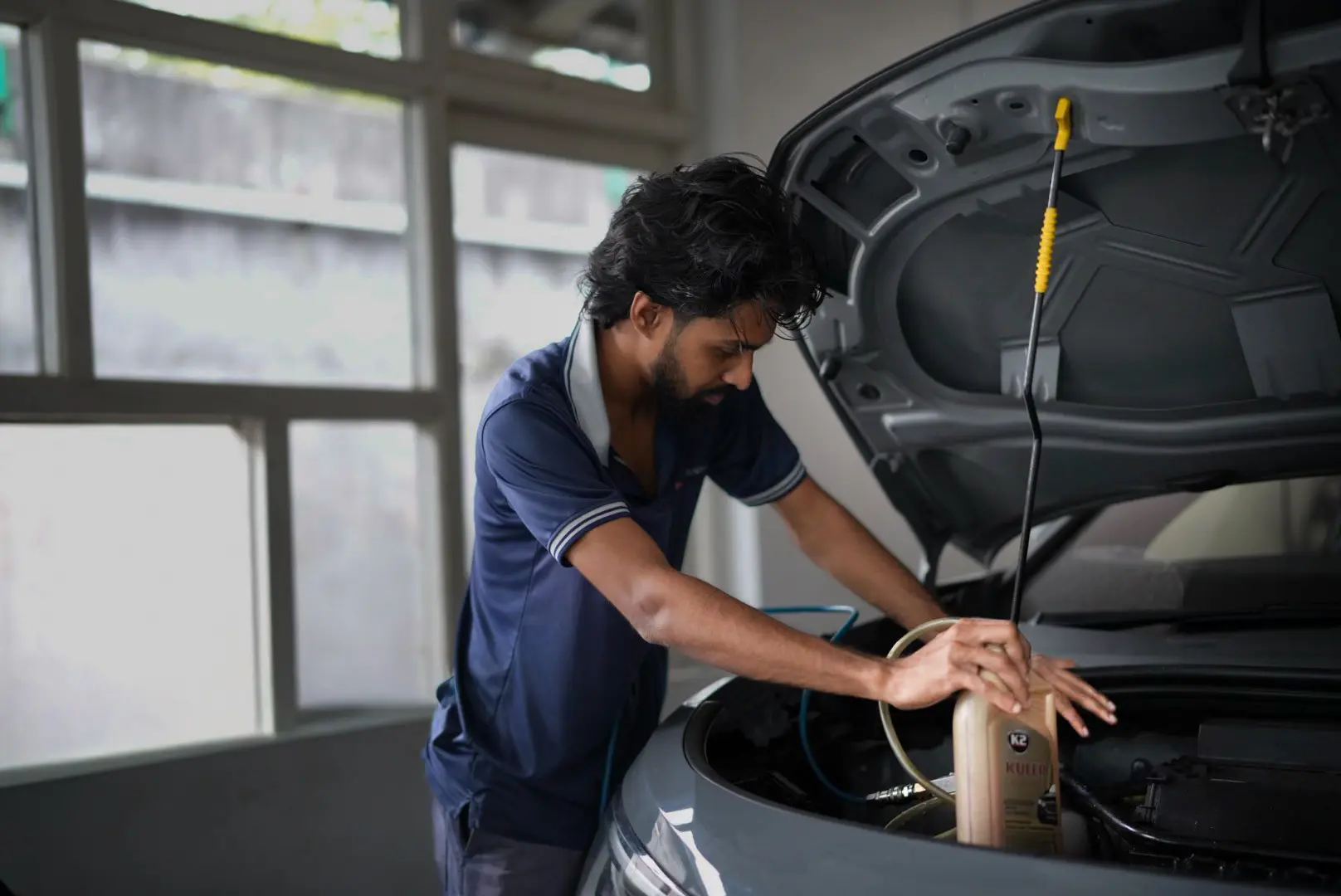 Mechanic at Ideal using Lubricant