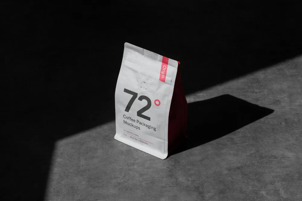 Stand-up pouch coffee packaging mockup in a matte black finish with bold white and purple accents. Displayed on a textured purple surface with dramatic lighting casting deep shadows.