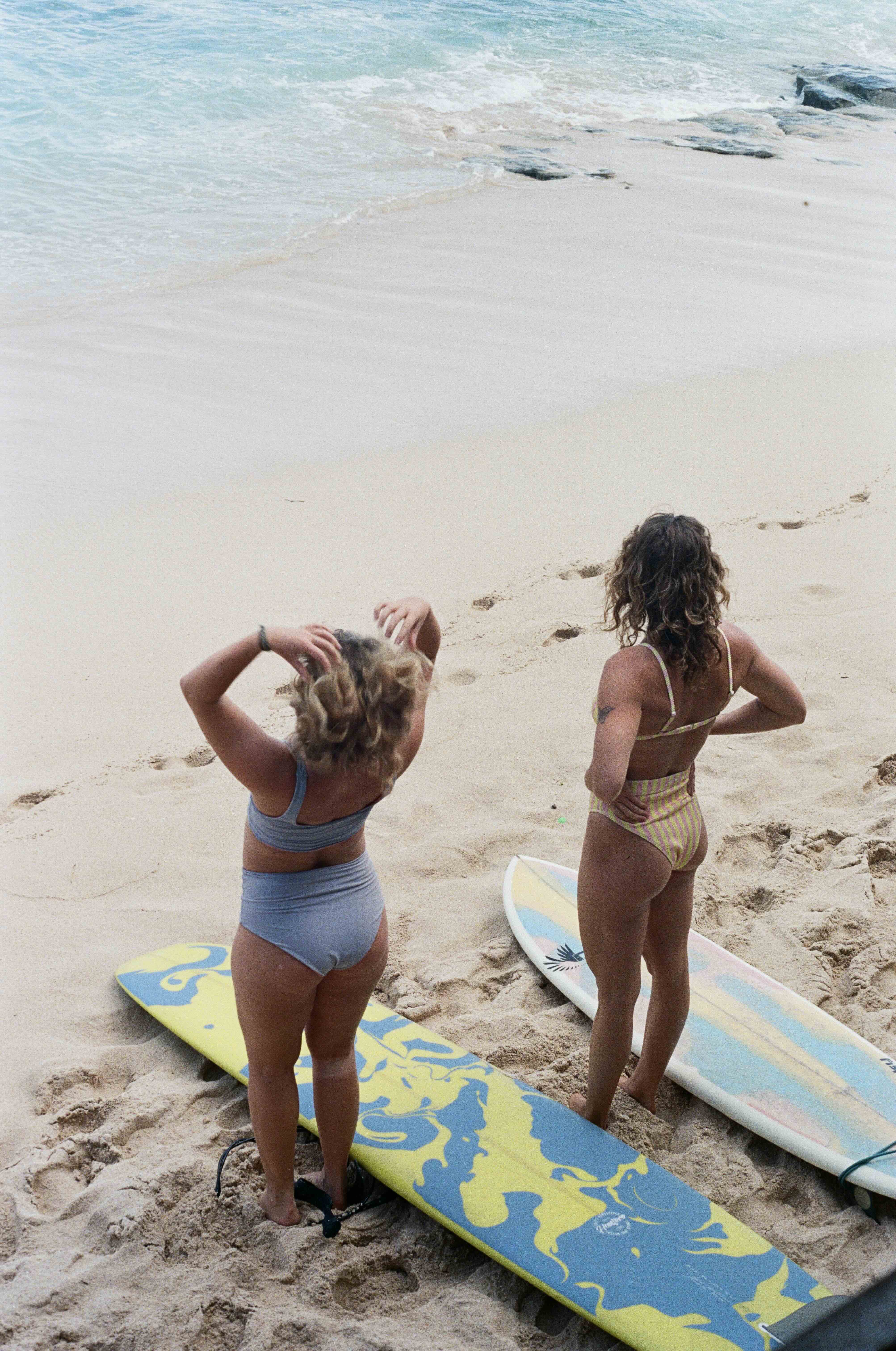 longboard surfer girls preparing for a surf session