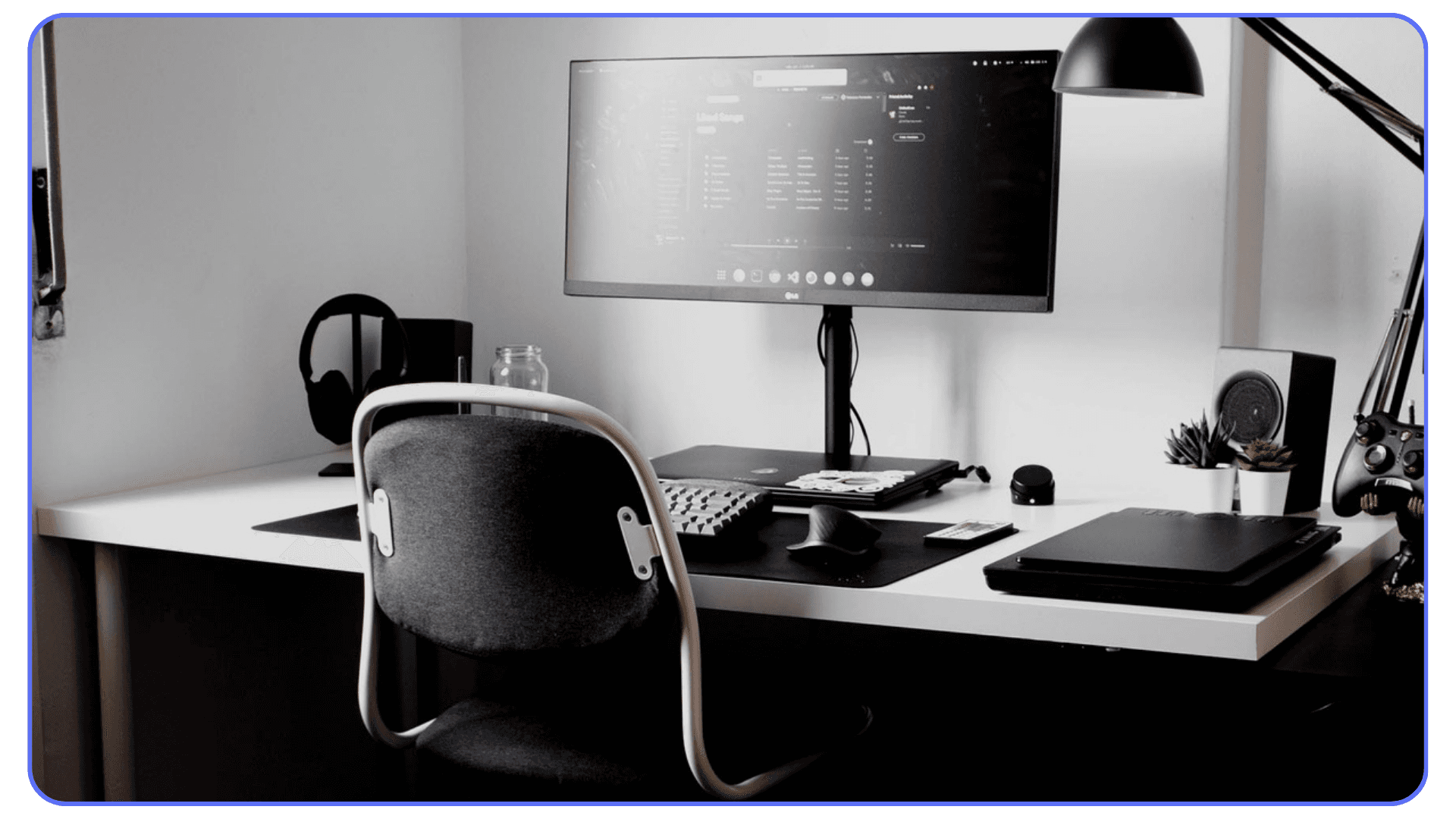 Minimal home workspace with ultrawide monitor and laptop used for architectural design work