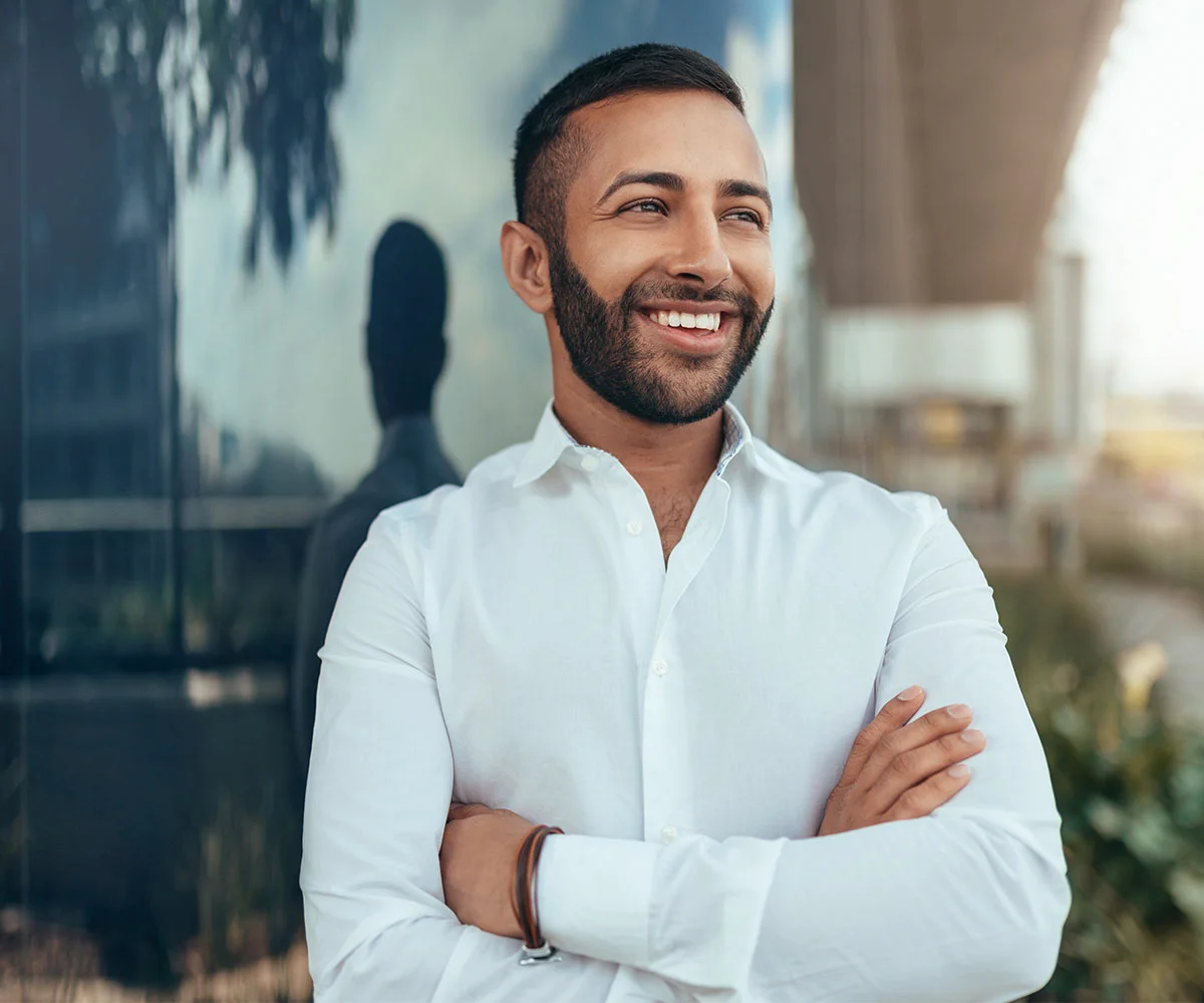 Smiling patient portrait representing restored confidence and a positive oral surgery experience.