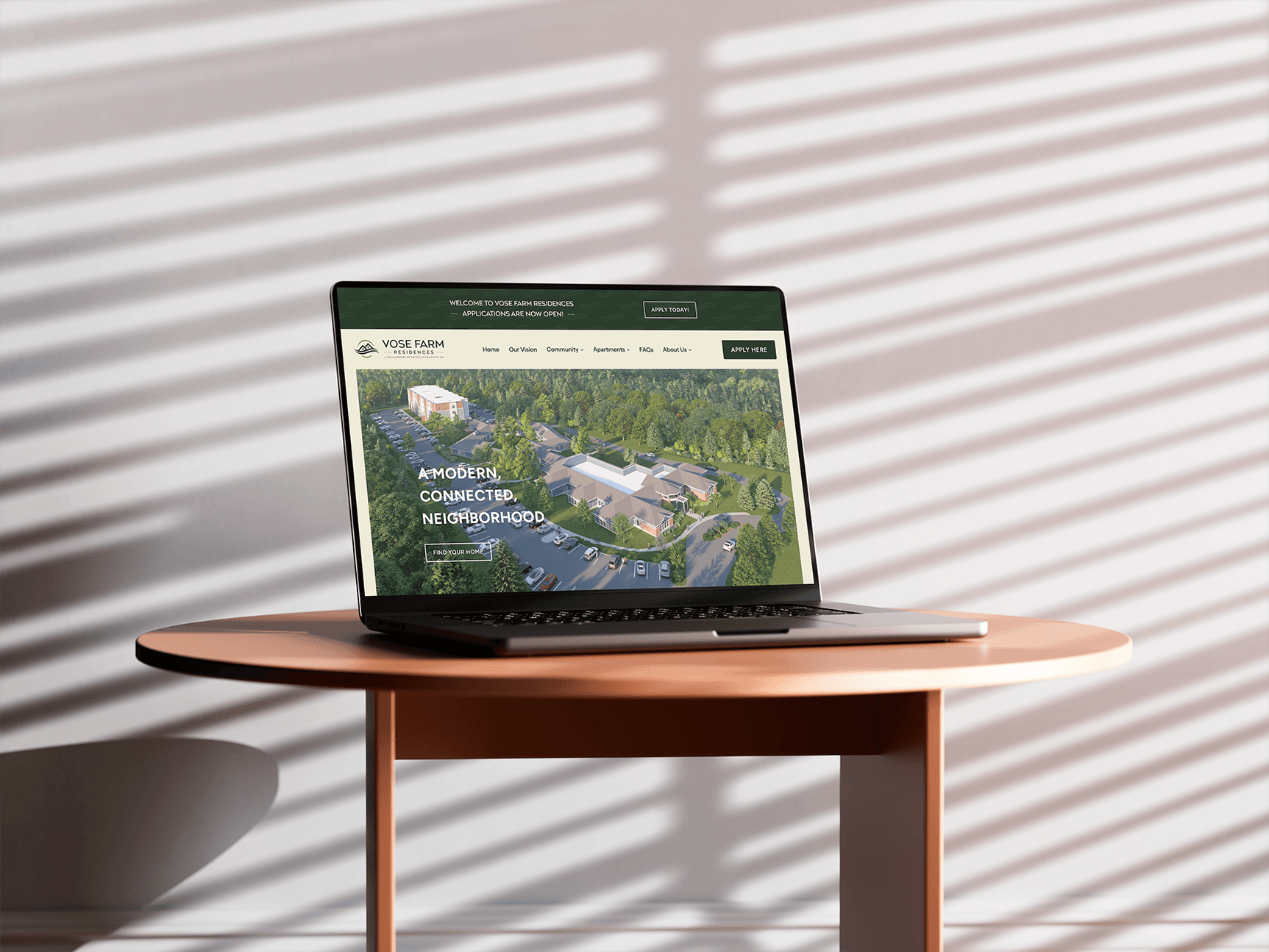Graphic design mockup of a laptop with a website forVose Farm Residences — earthy, clean wordmark logo of a house and river with a clean sans serif typography, designed by Will Lefkovich.