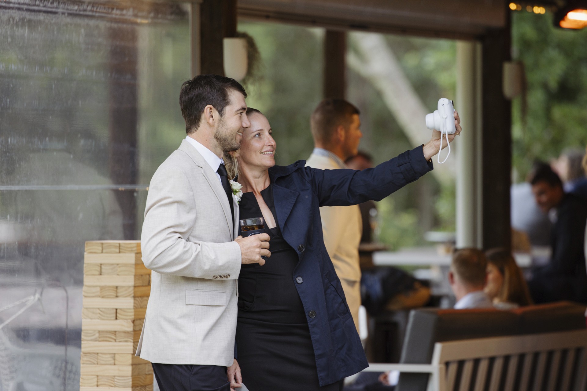 Couple taking selfie with polaroid camera