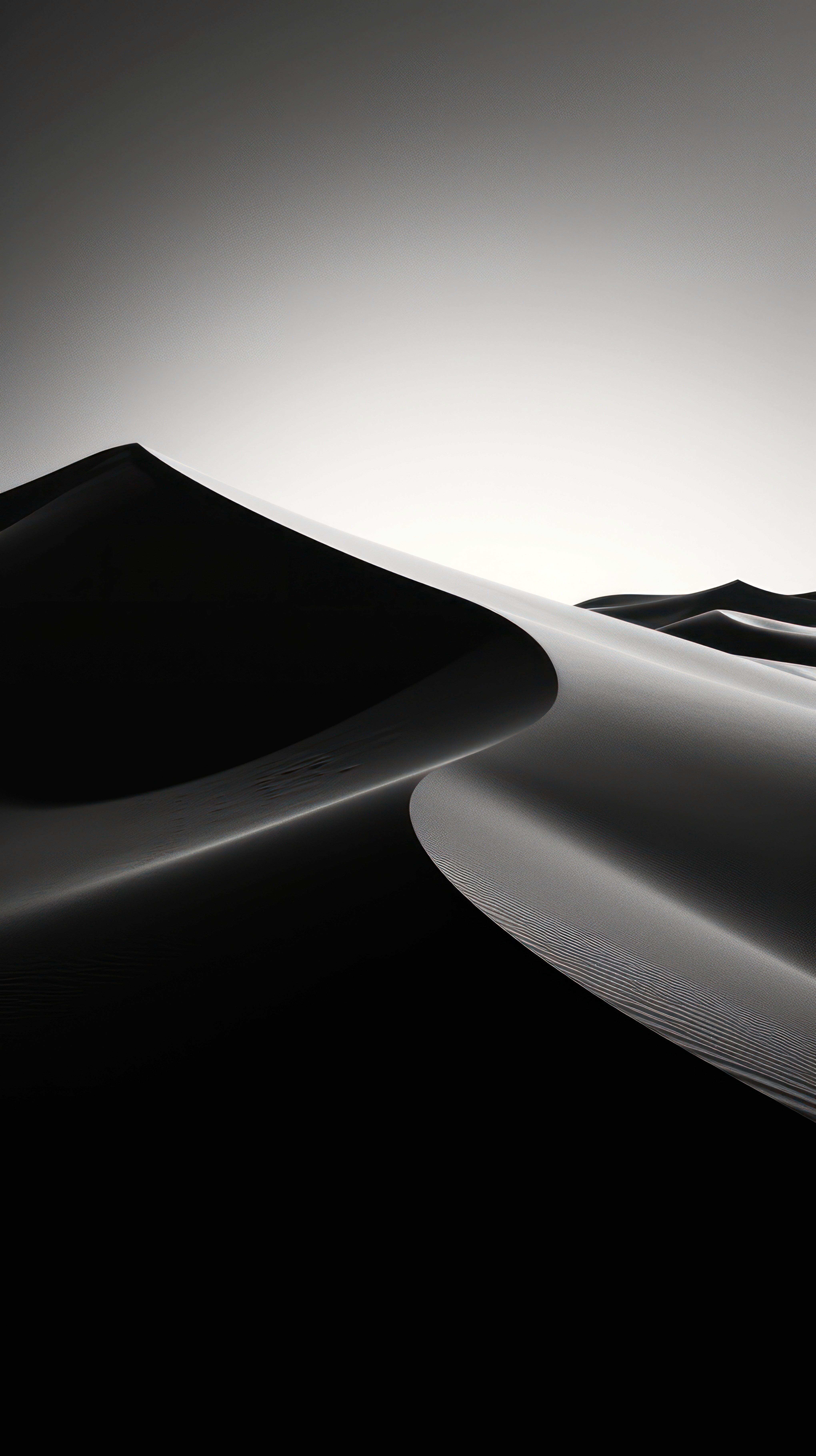 Abstract close-up of curved shapes resembling sand dunes, with strong contrast between light and shadow, in black and white.