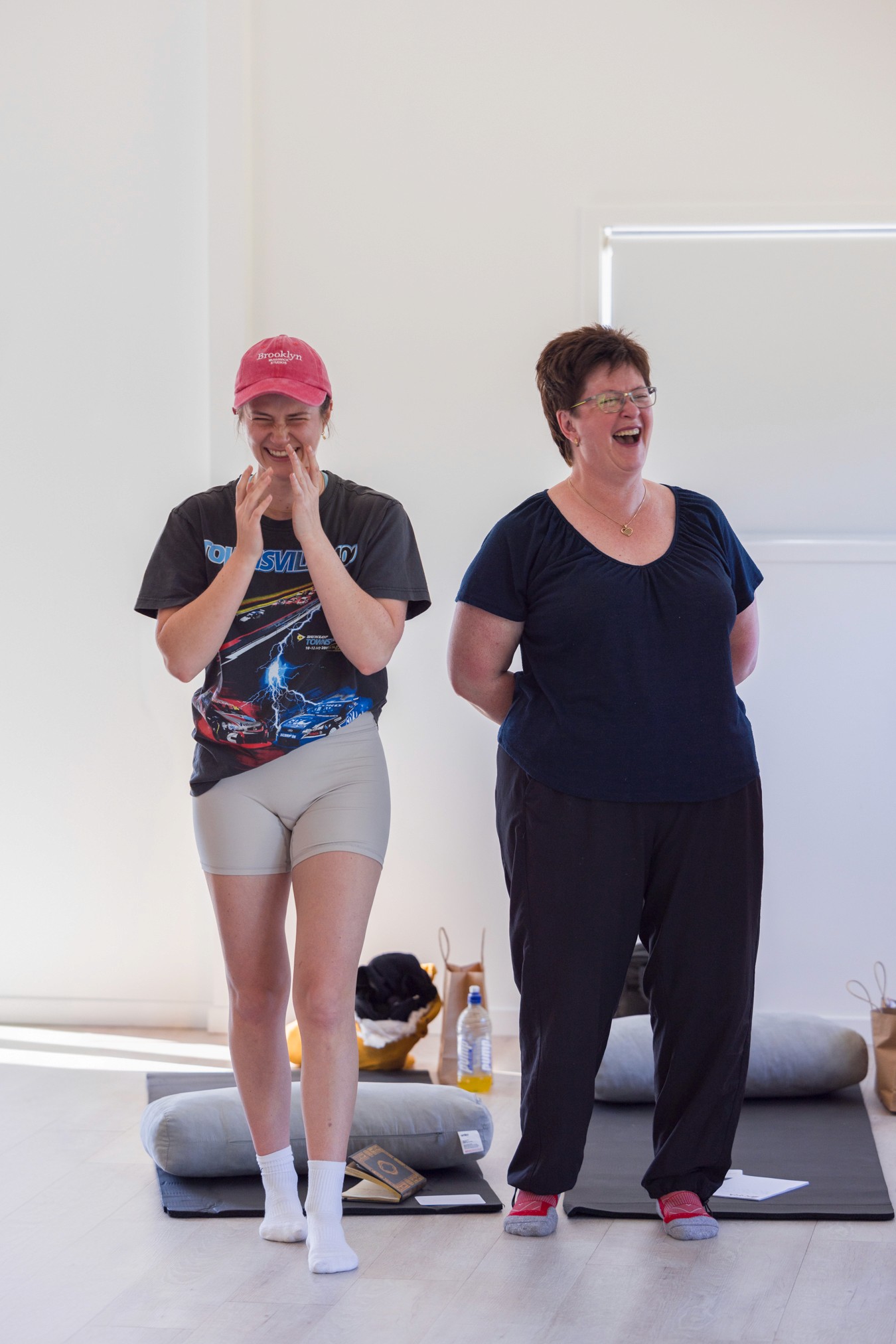Two women standing next to each other laughing
