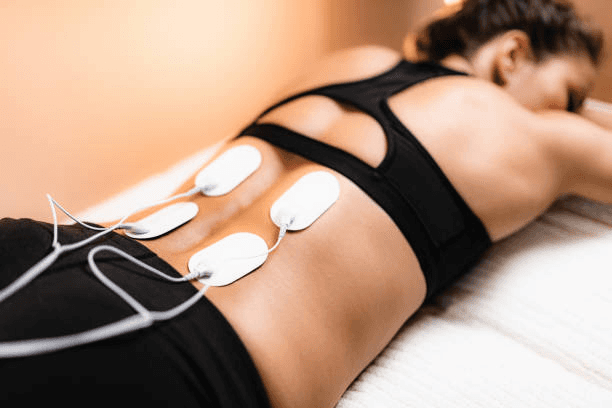 Non-invasive back pain treatment at Advantage Physical Therapy using electrical stimulation to relieve tension and promote healing.