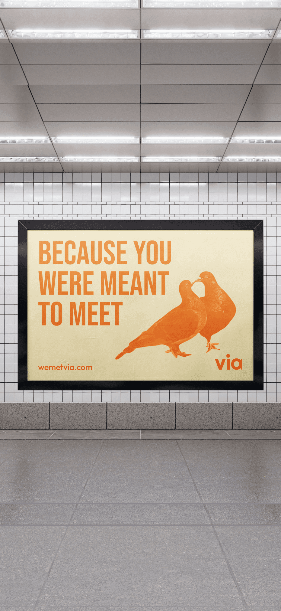Subway station viewed from the platform. The ad features kissing pigeons and says "because you were meant to meet"