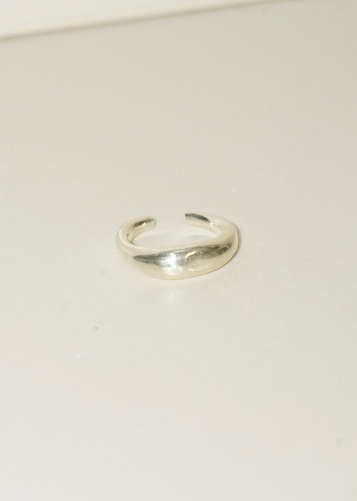 Silver ring on a light beige background