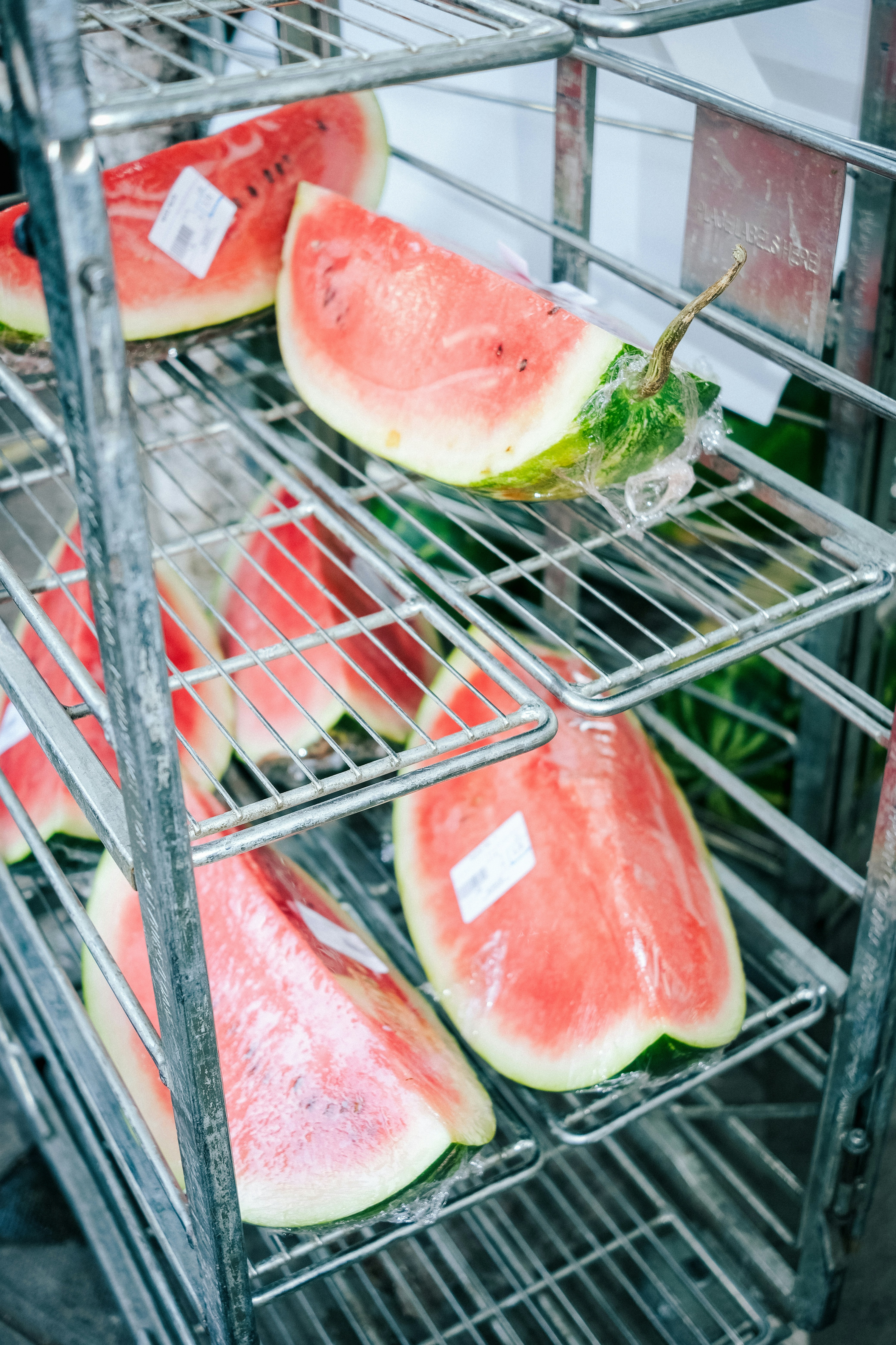 a metal rack filled with slices of watermelon