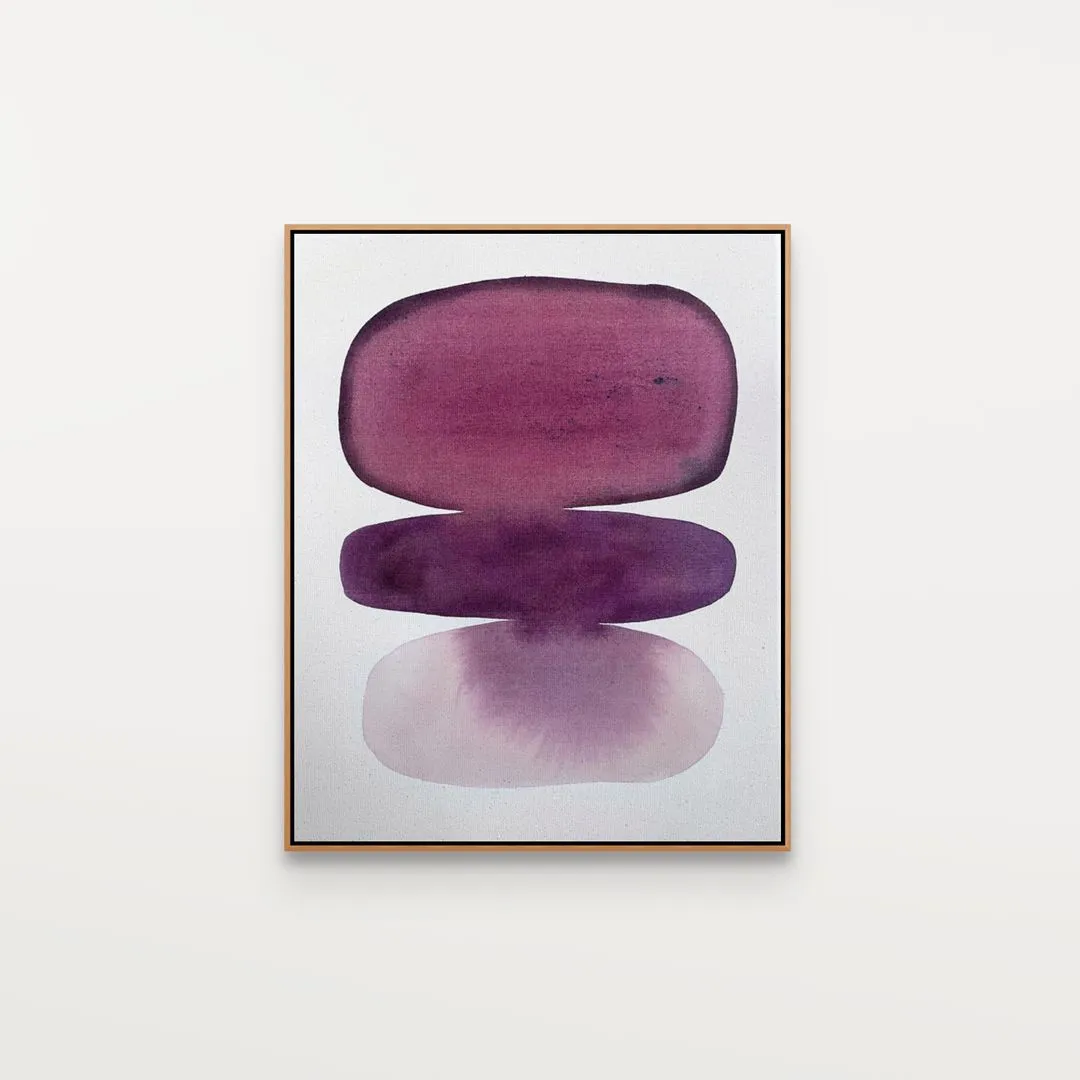 Two purple, oval shapes stacked vertically within a thin, gold frame against a light background.