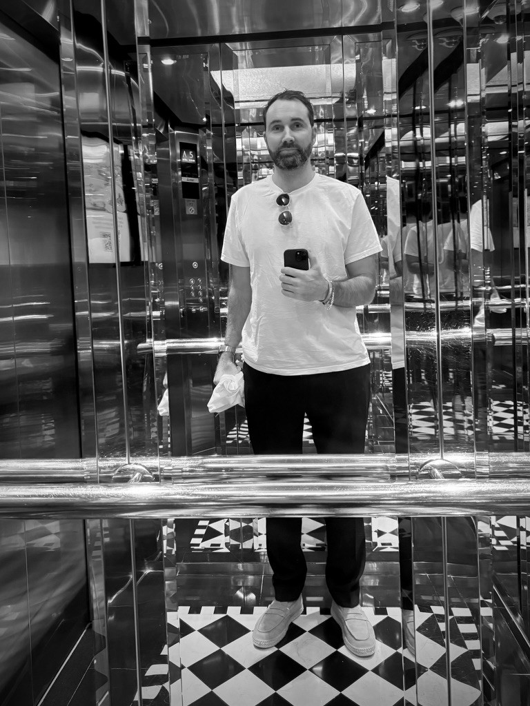 Red table lamp on a pink stone counter in a wood-panelled interior