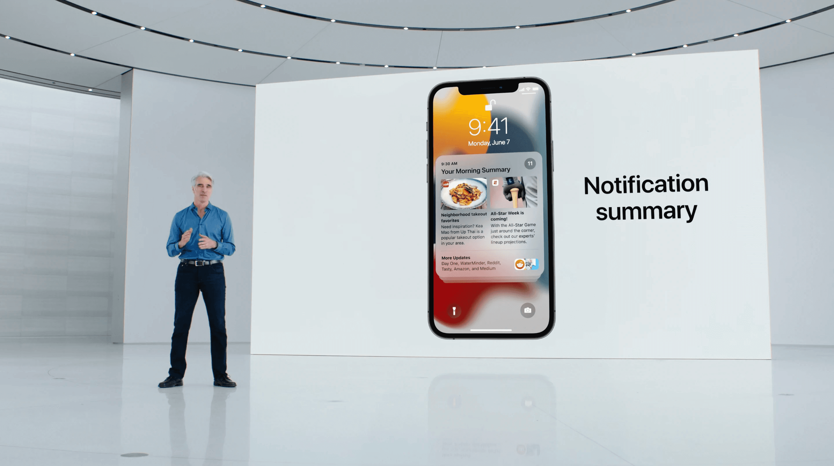 Close-up of a presentation screen featuring an iPhone and the words ‘Notification summary’ during a product talk.