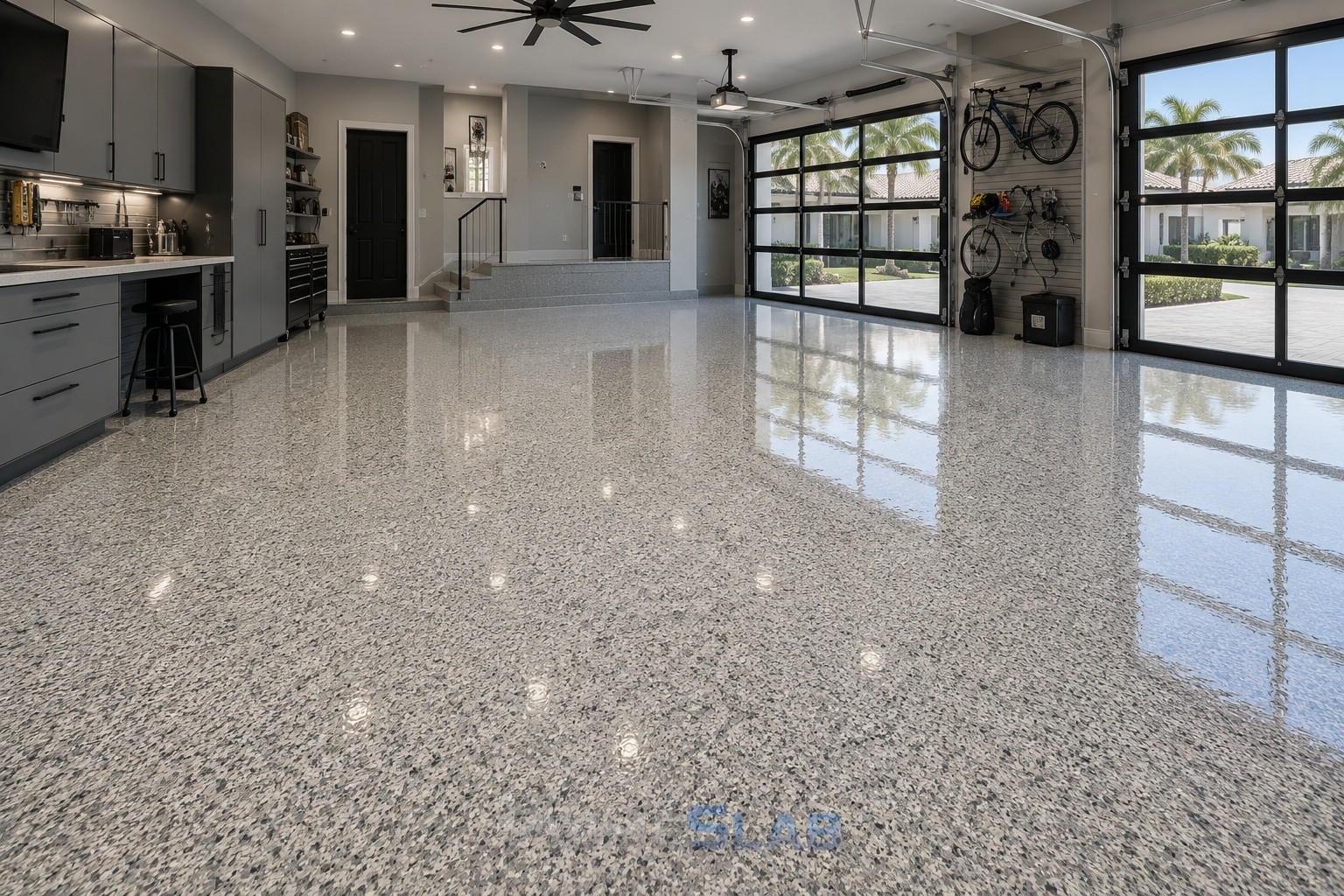 Bright garage with a finished light gray flake floor and organized wall storage.