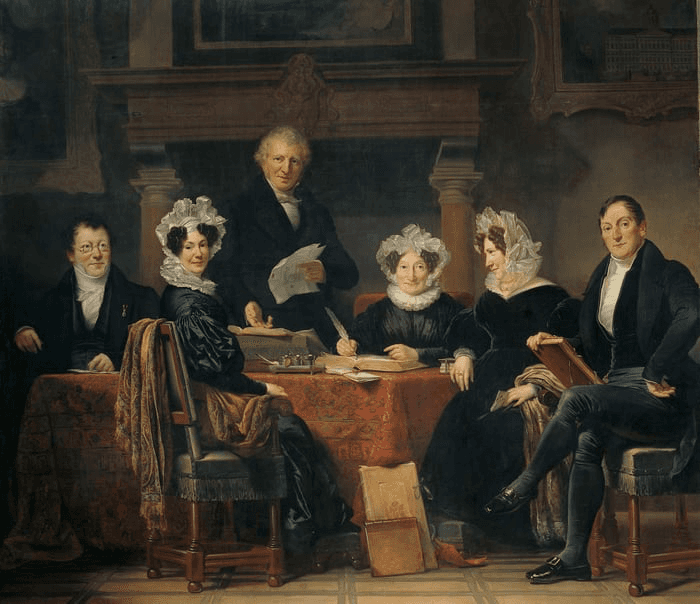 A historical painting of six people, seated around a table, dressed in 18th-century clothing, engaged in conversation.