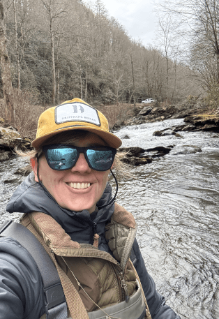 woman smiling at camera with water background