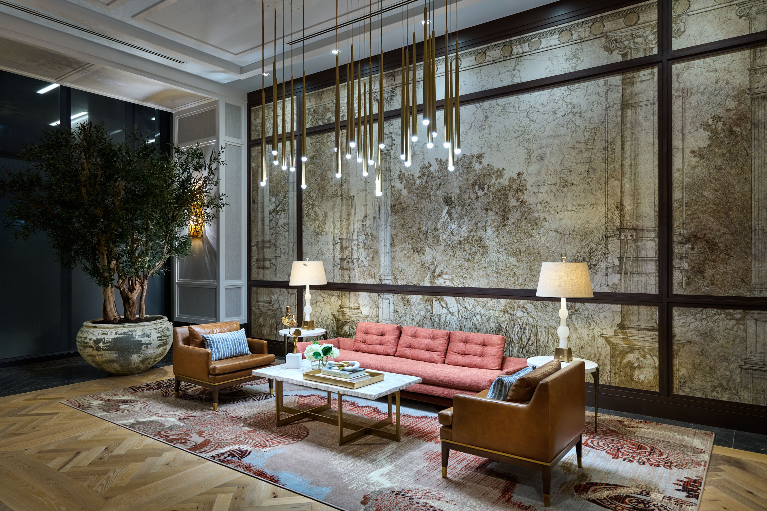 Lounge area with modern chandelier and vintage-style wall art.