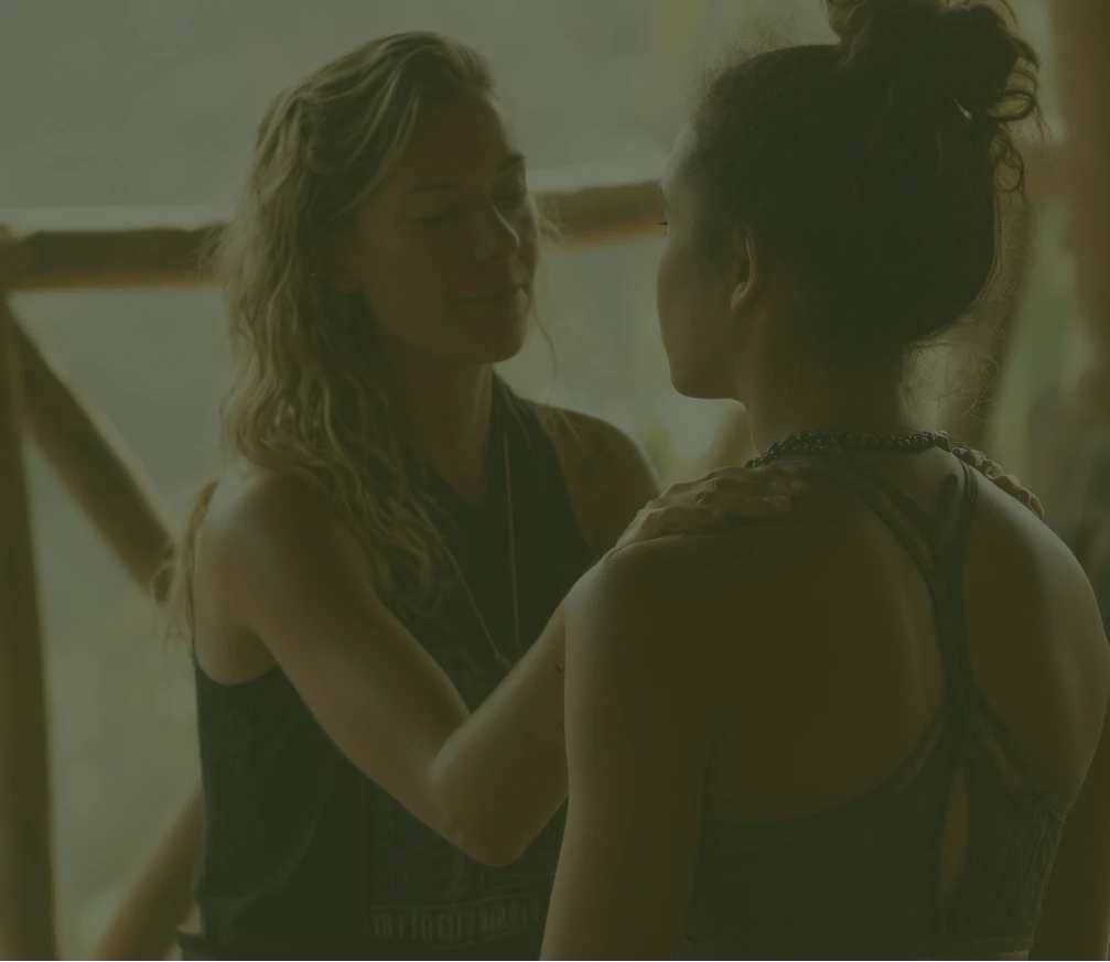 Yoga instructor assisting a student