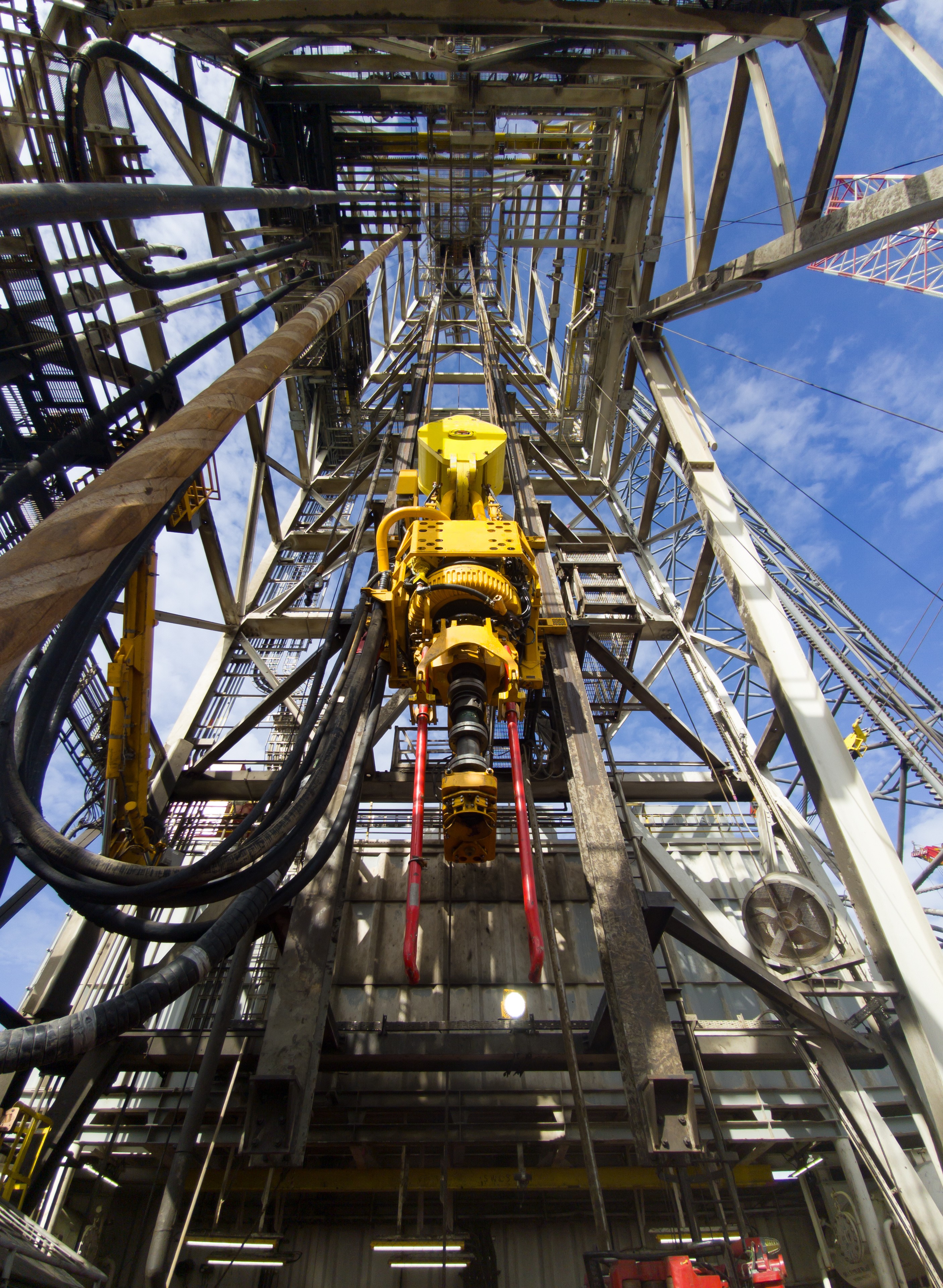 A man in a white lab coat working at a computer, viewing a 3D model on the screen in a laboratory or office setting.