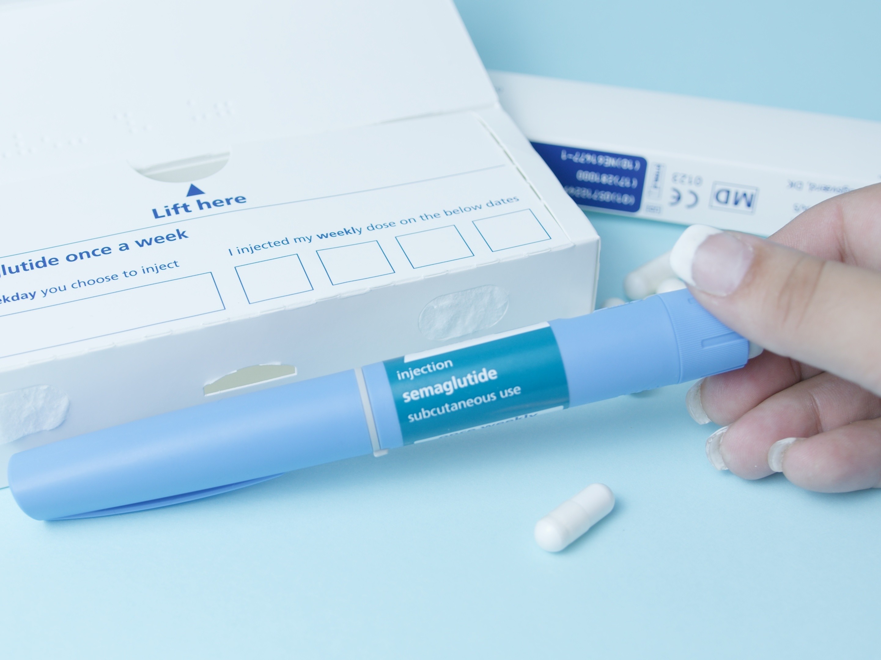 woman holding the best shot for weight loss containing semaglutide