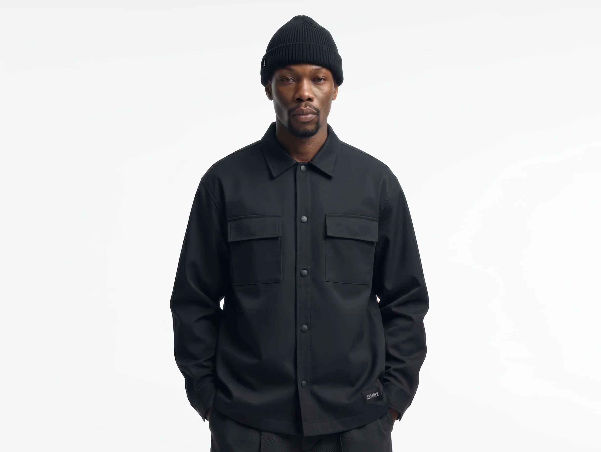 Studio portrait of a model wearing a structured overshirt from Assembly fashion label.