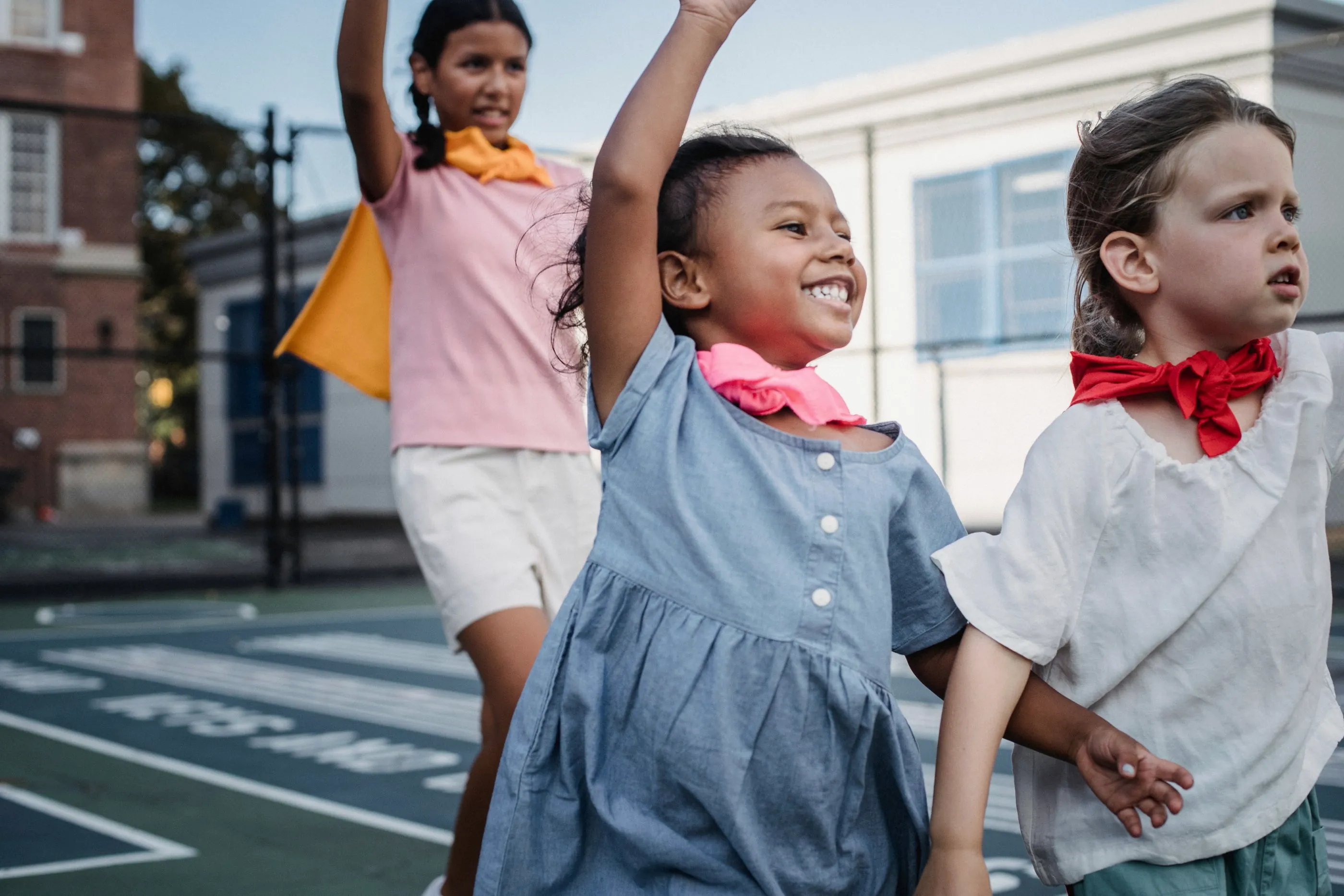 Kids cheering and laughing on a playground