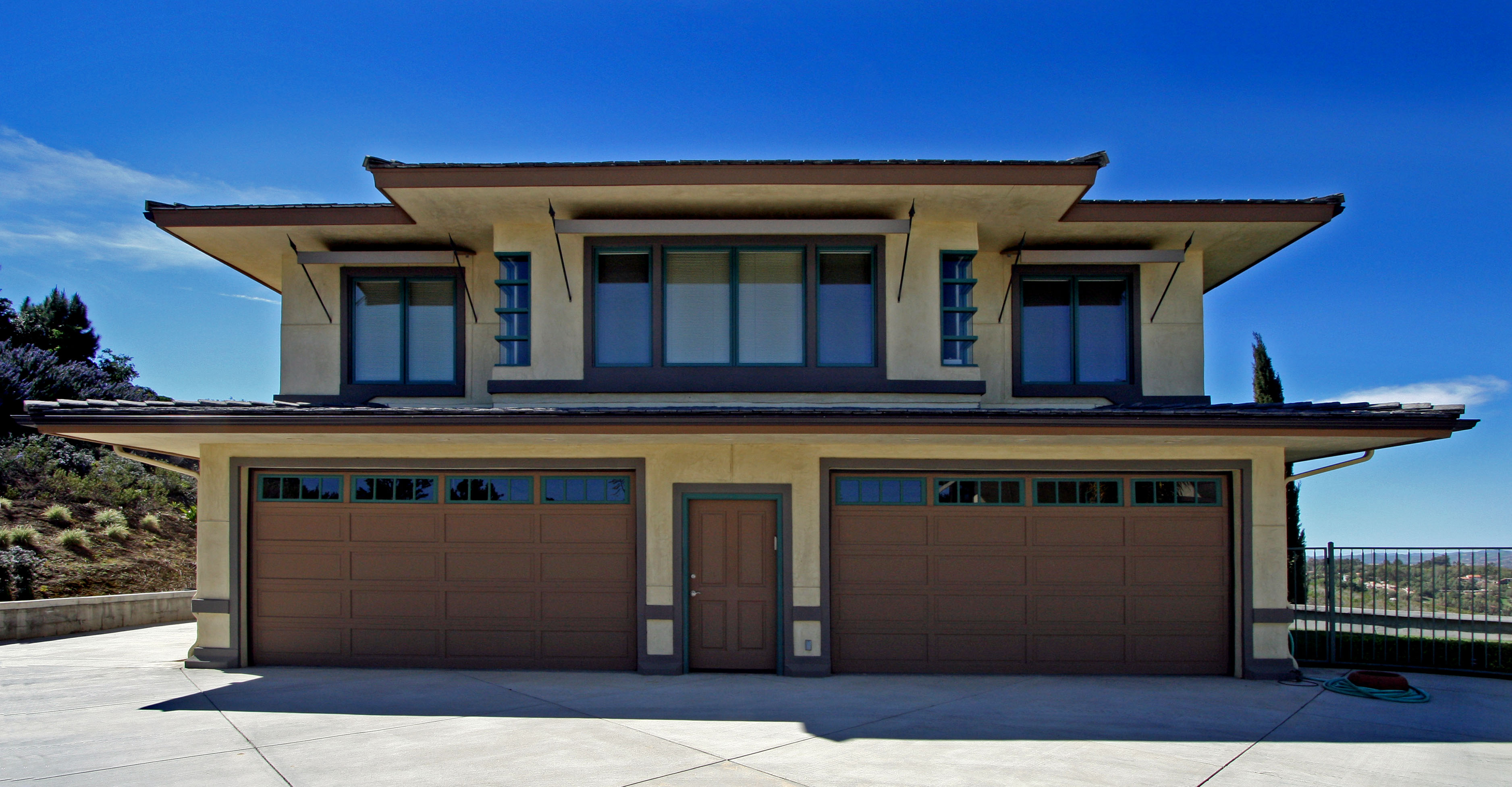 Garage view with a blue sky, focusing on the architectural elements and the natural connection to the exterior space.