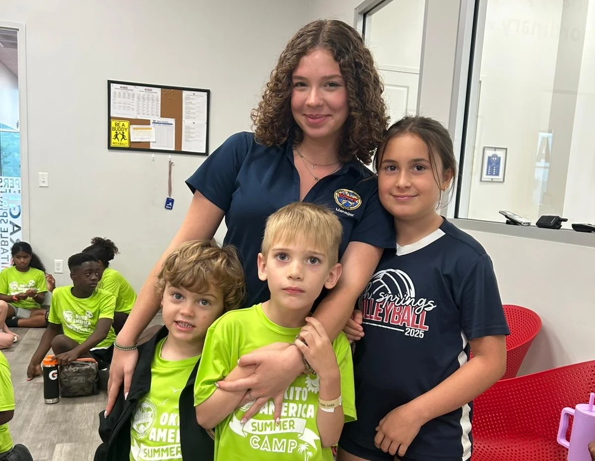 Couselors with three kids smiling at camera